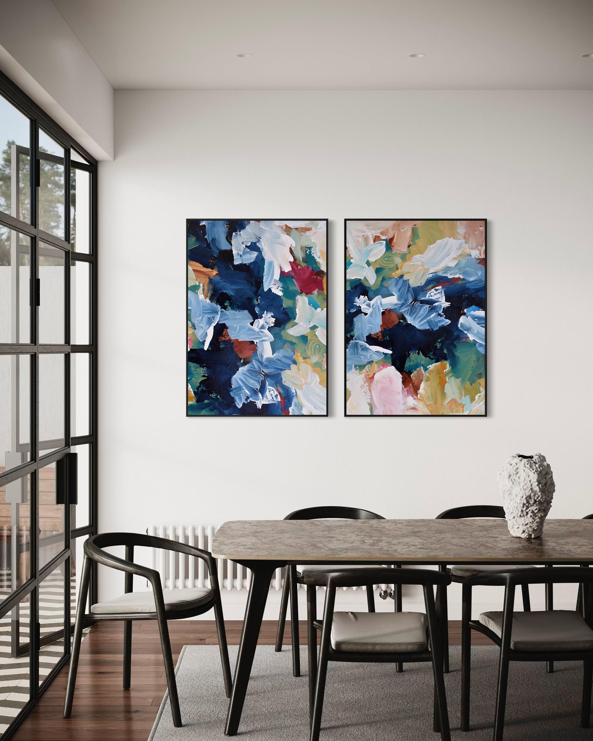 Dining room with abstract art on the wall and a wooden table.