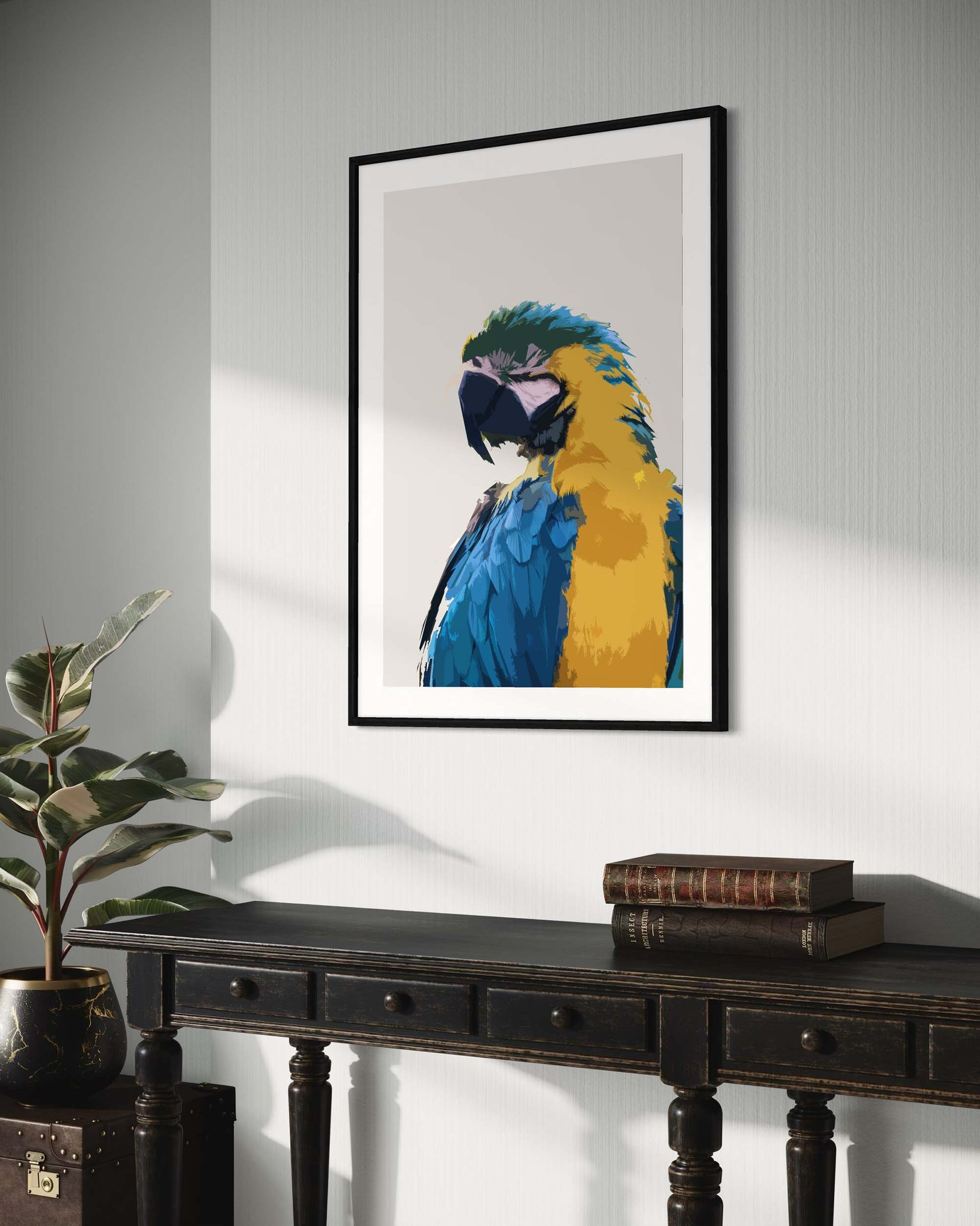 Framed artwork of a colorful parrot on a wall above a wooden table.