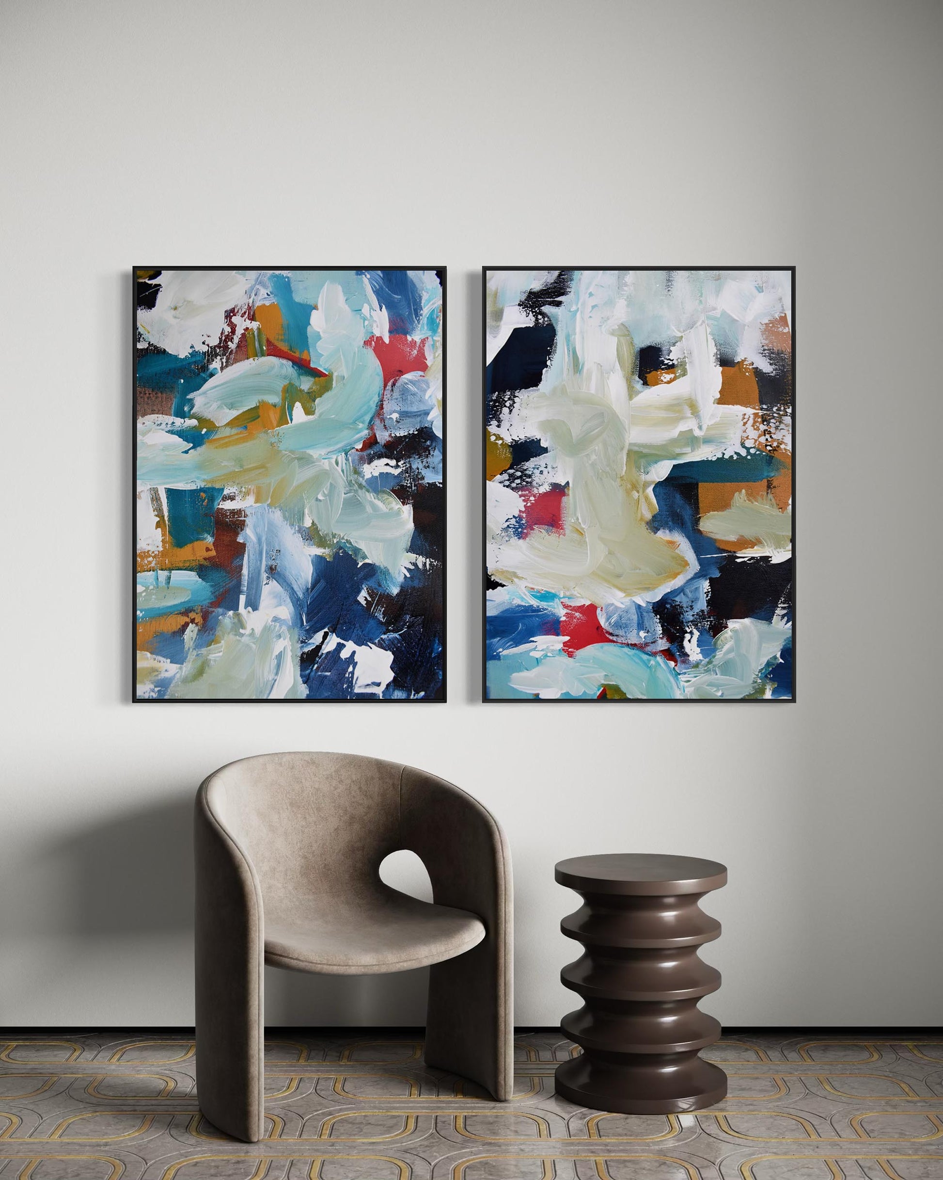 Two abstract paintings on a wall with a chair and table below.