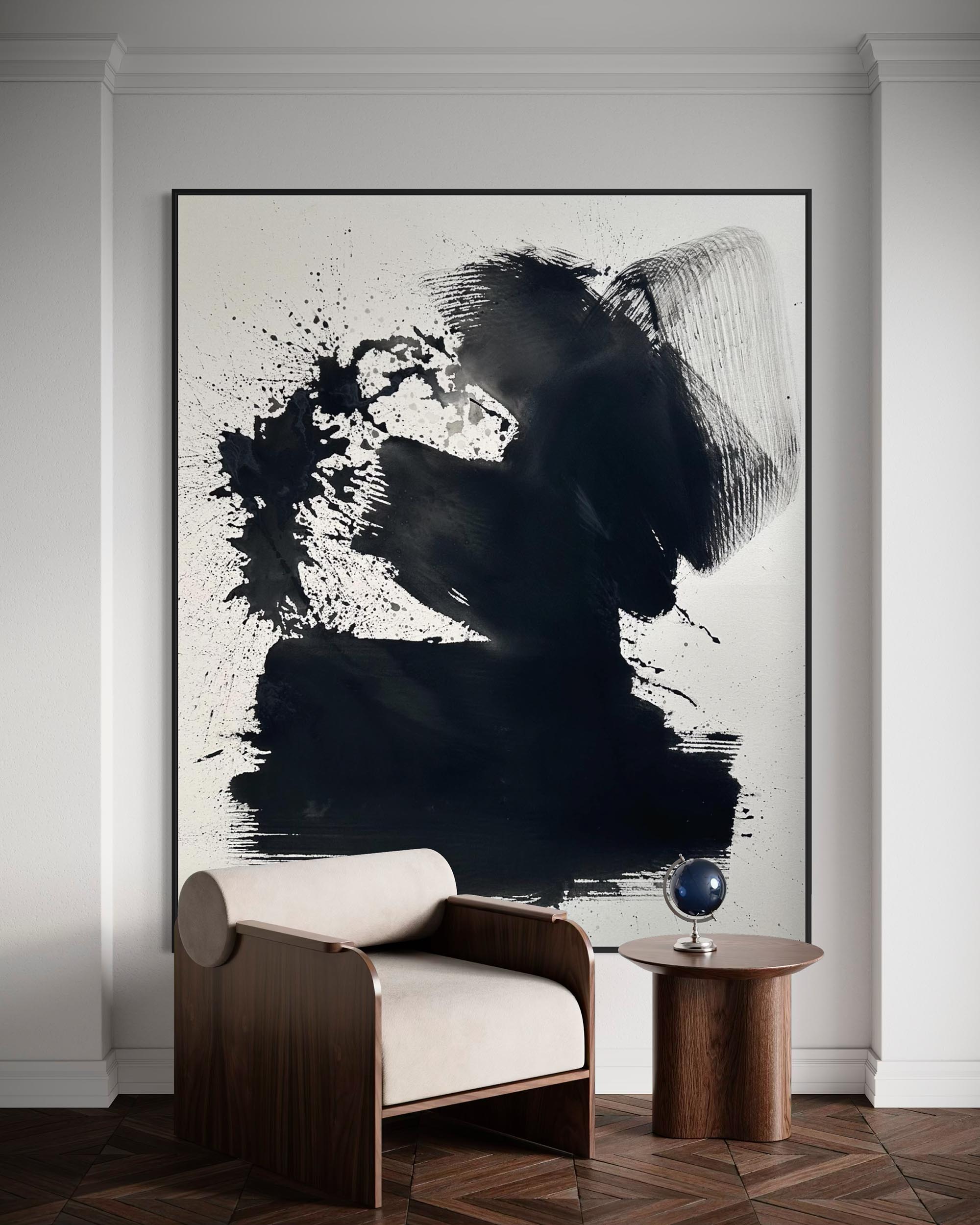 Modern interior with abstract black and white painting, armchair, and side table.