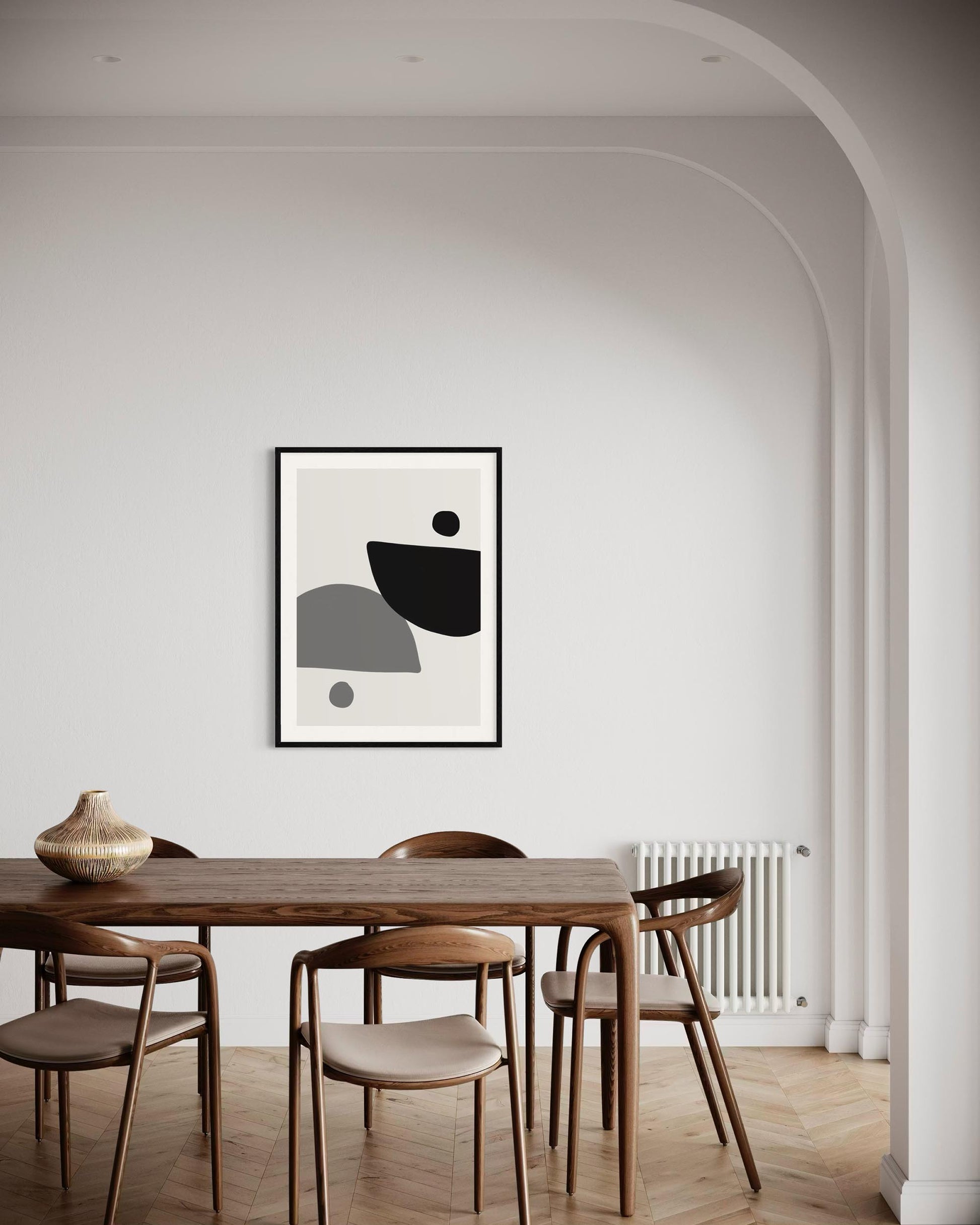 Dining room with a wooden table and chairs, abstract art on the wall.