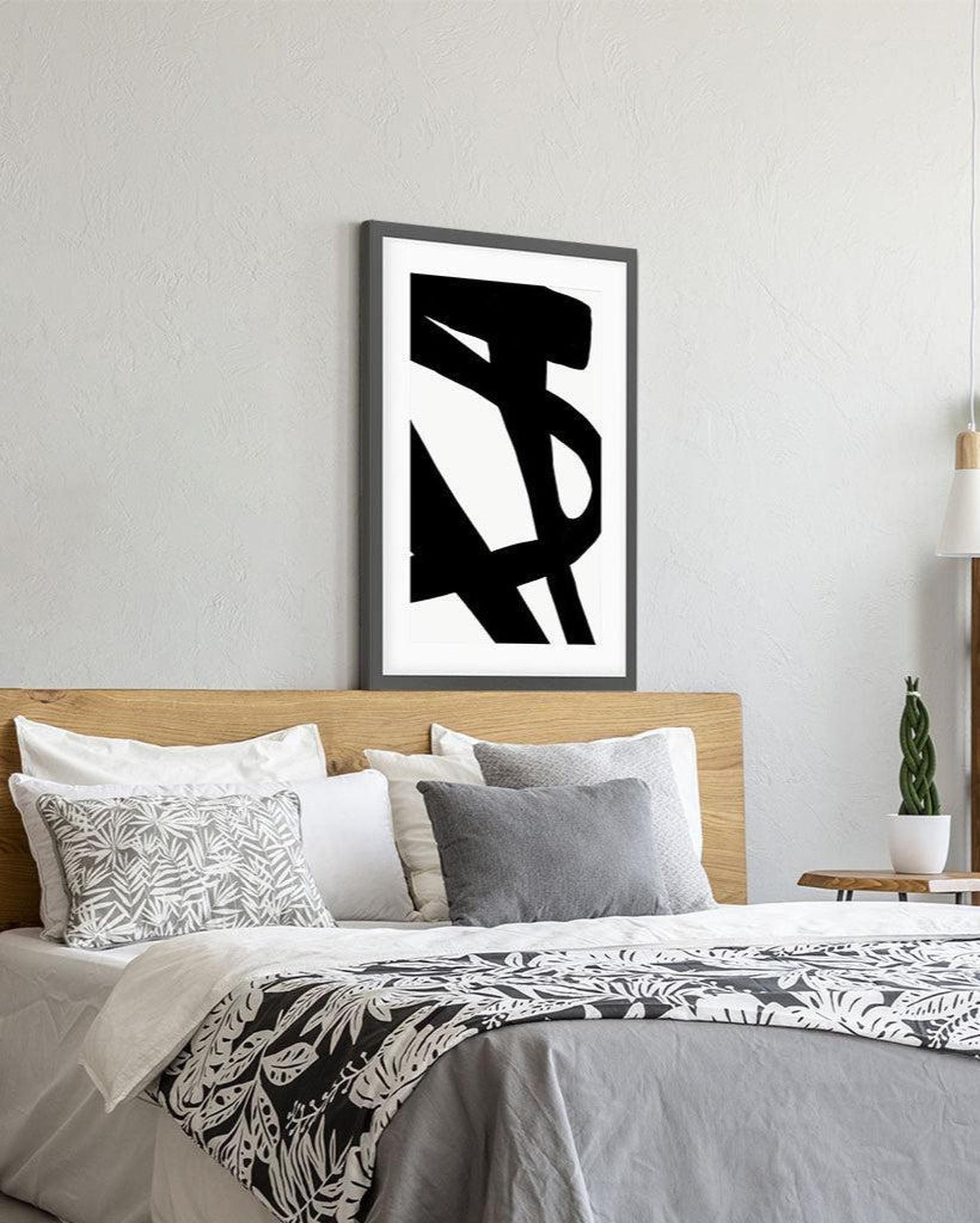 Modern bedroom with abstract black and white artwork on the wall