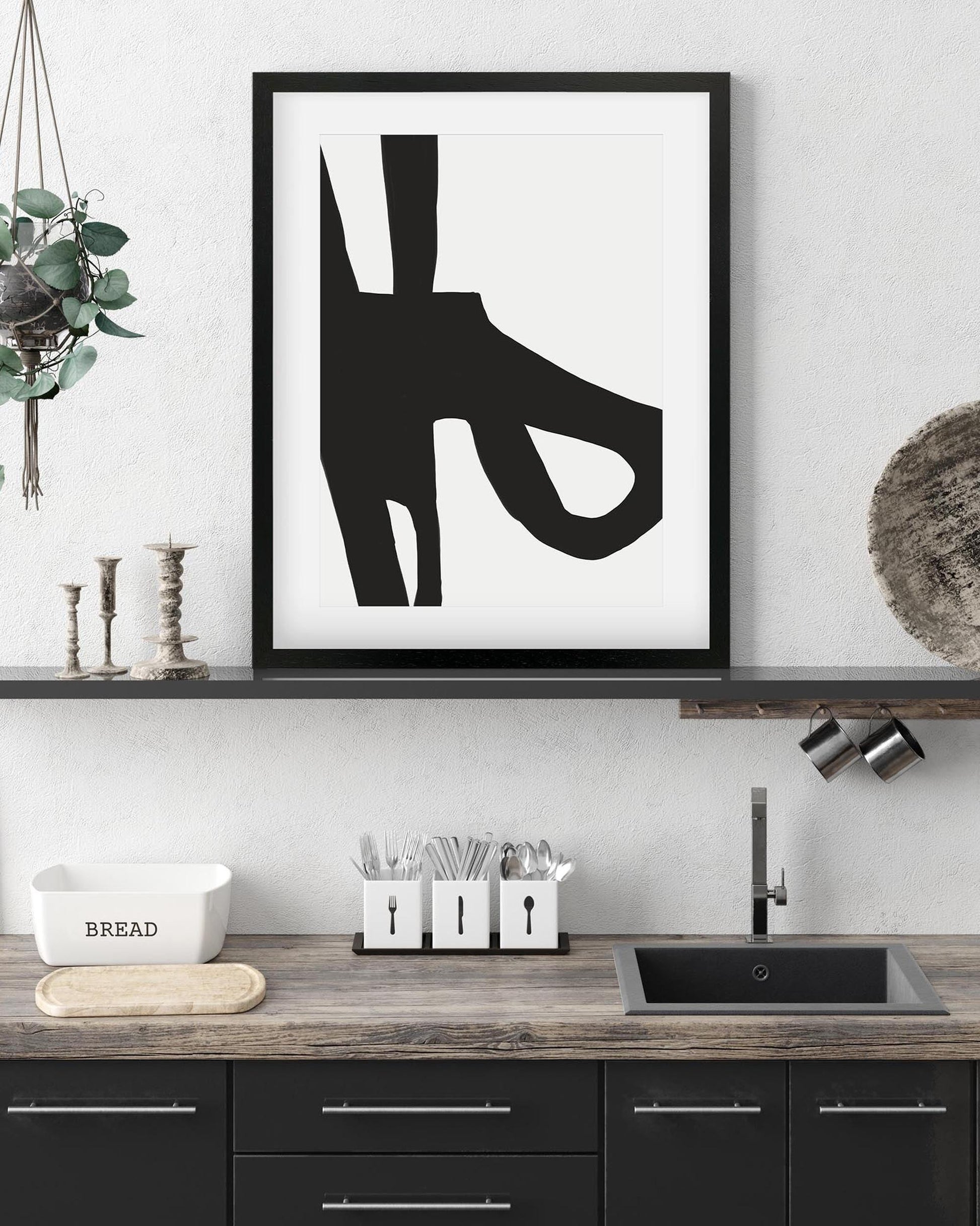 Modern kitchen with abstract black and white artwork on the wall.