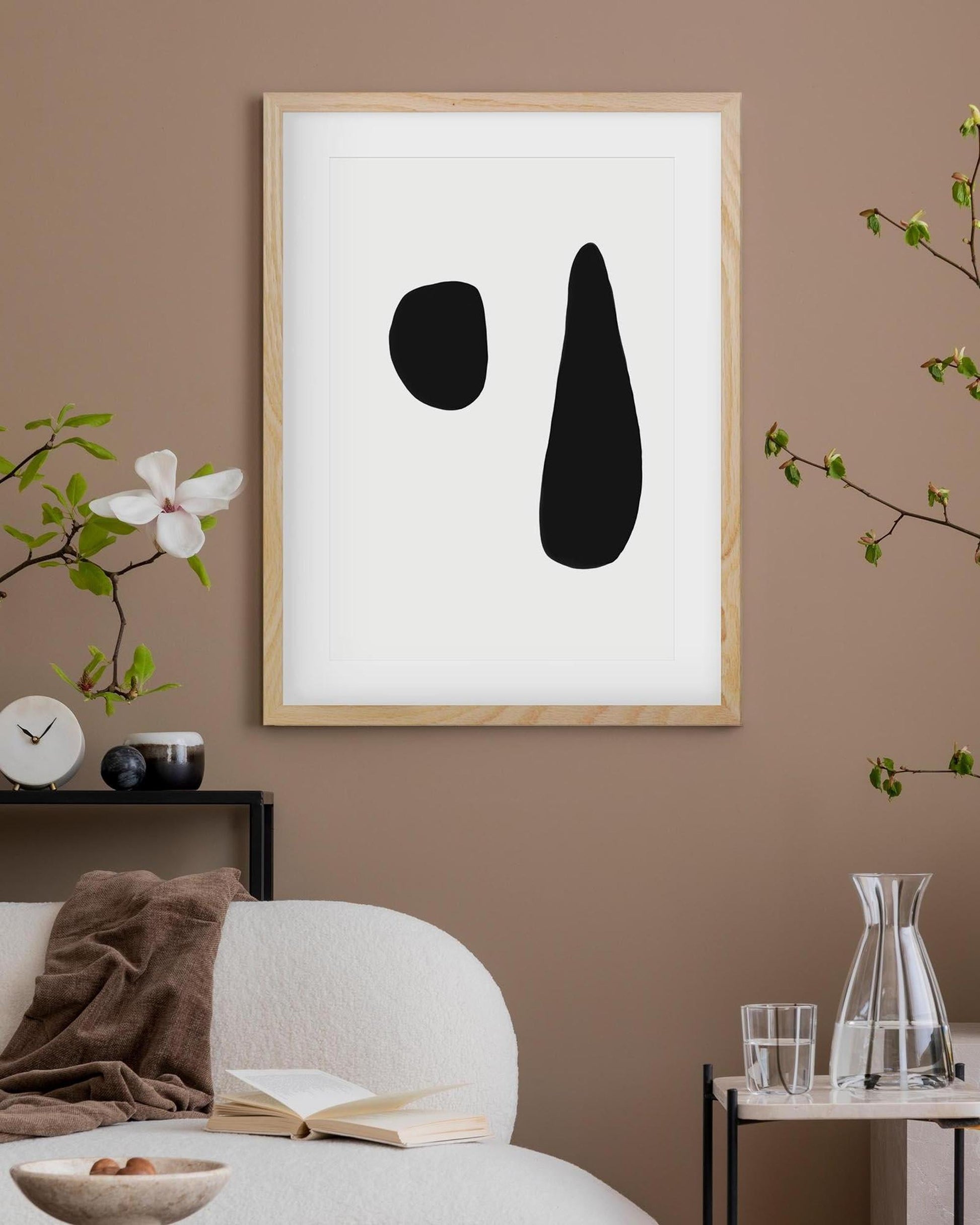 Framed abstract art piece on a wall with minimal decor