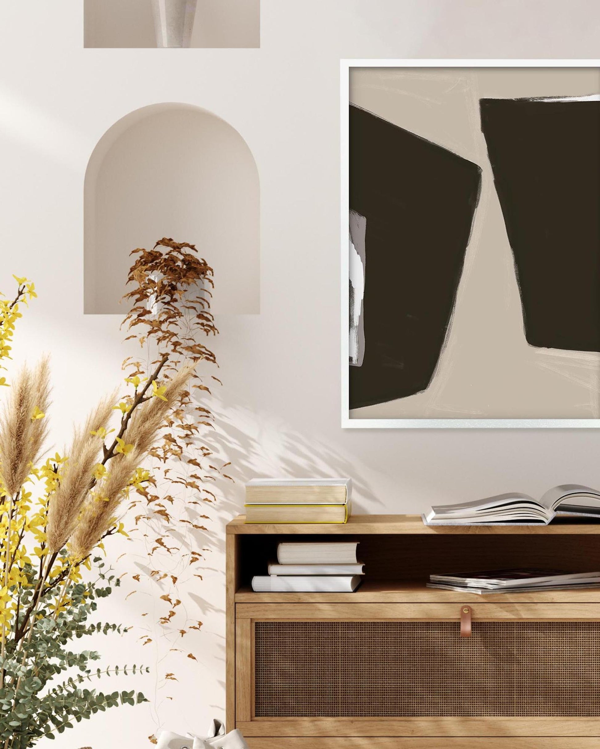 Wooden cabinet with books and decorative items, abstract art on the wall, and plants.