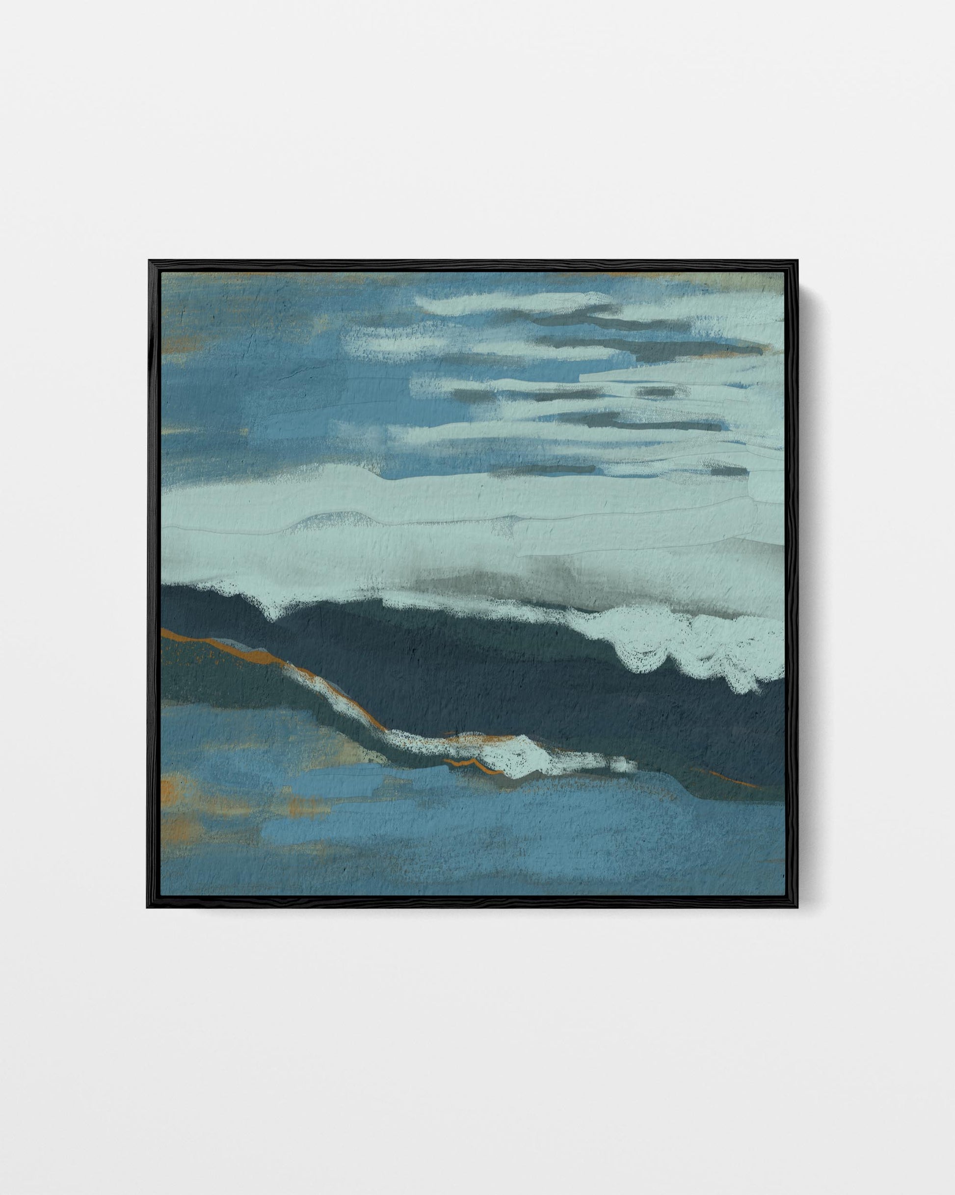 Framed abstract artwork with blue and green tones on a white wall