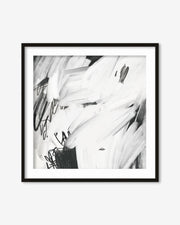 Framed black and white abstract art print on a white wall