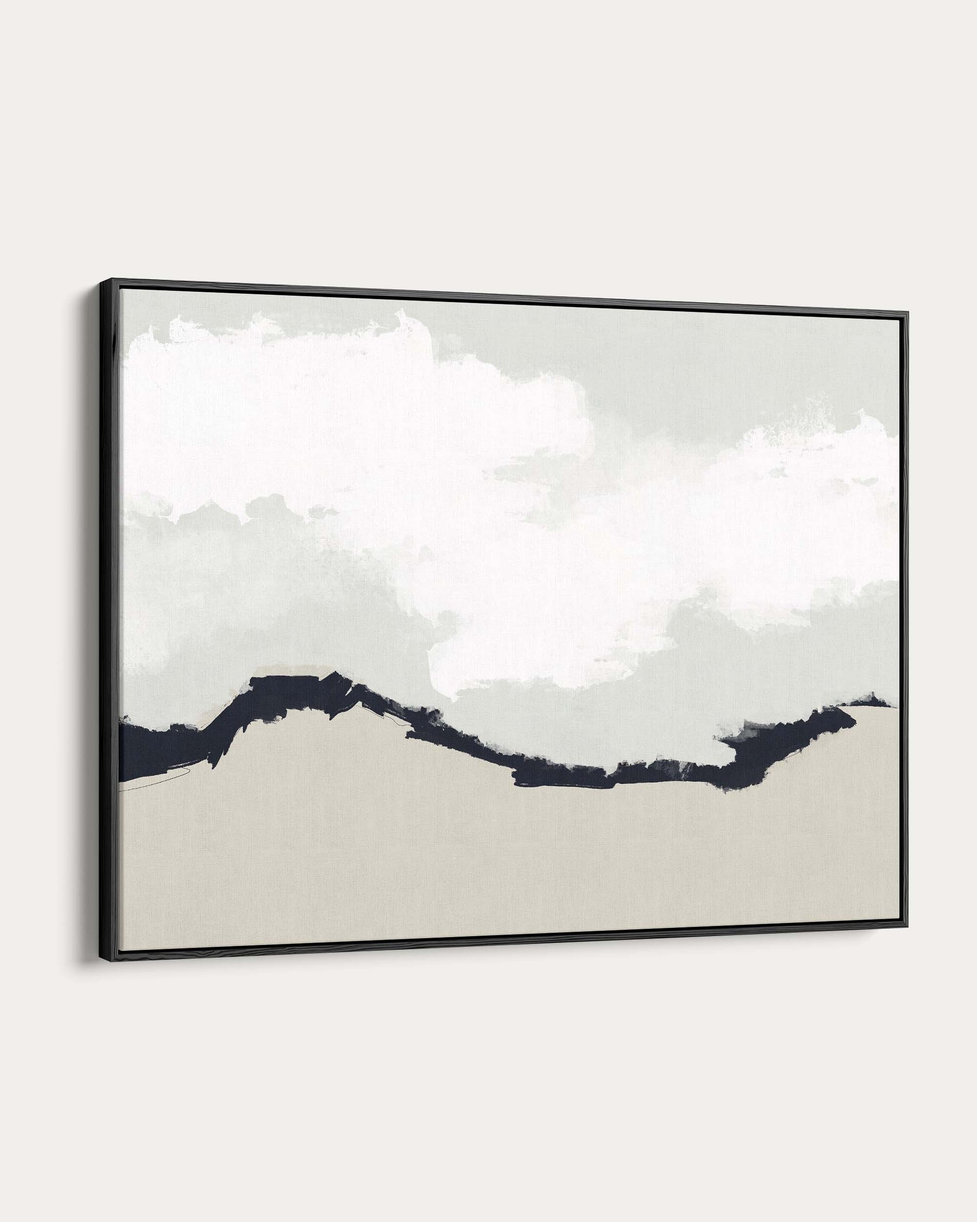 Framed artwork of a mountain landscape with clouds on a white wall