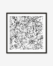 Framed black and white abstract art print on a white wall