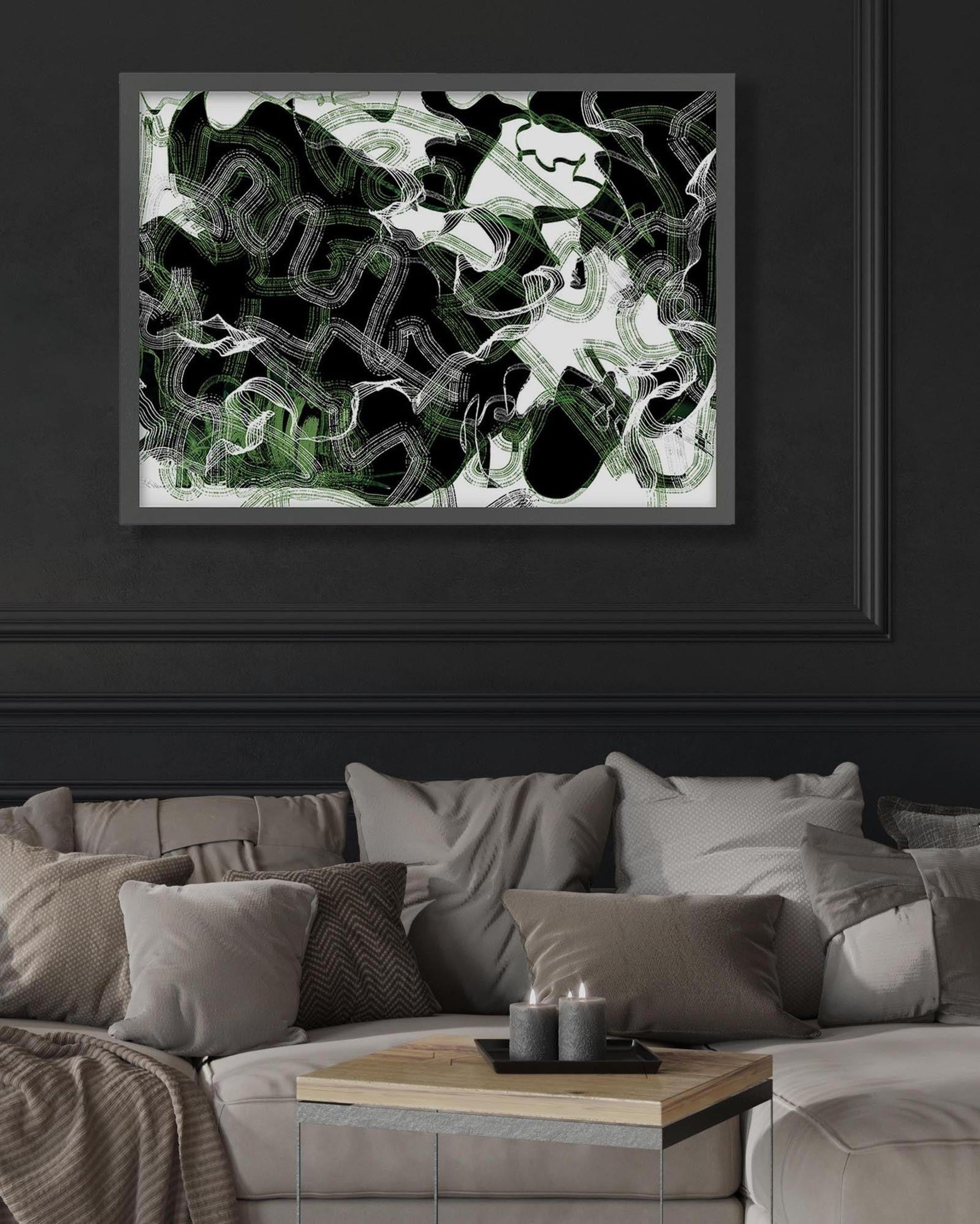 Framed abstract art piece on a dark wall above a sofa.