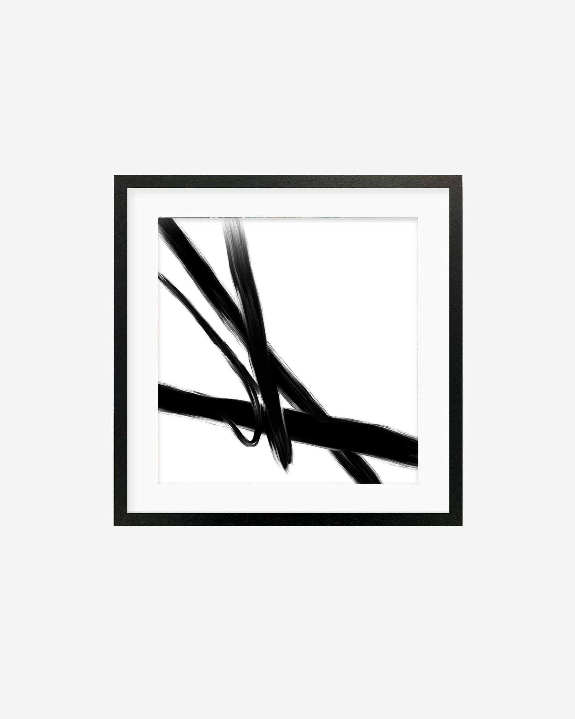 A framed art print featuring abstract black brush strokes on a white background.