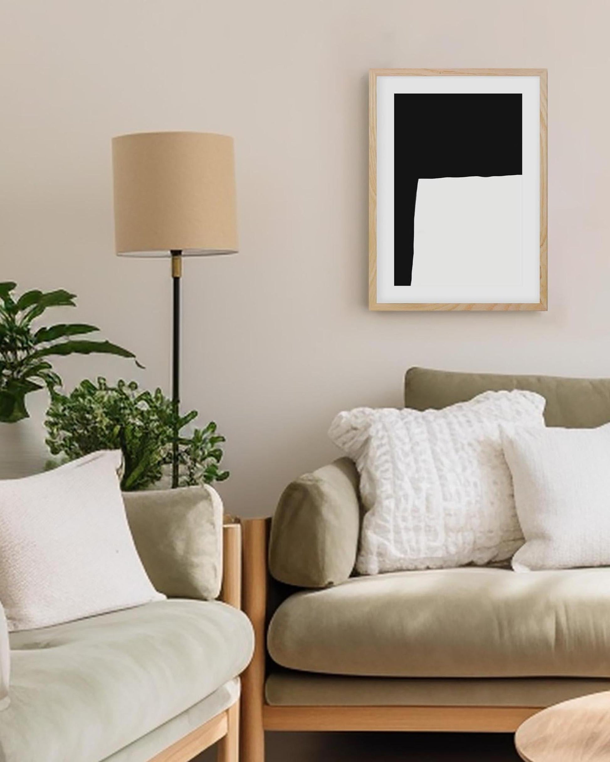 Living room with beige sofa, lamp, and abstract art on wall