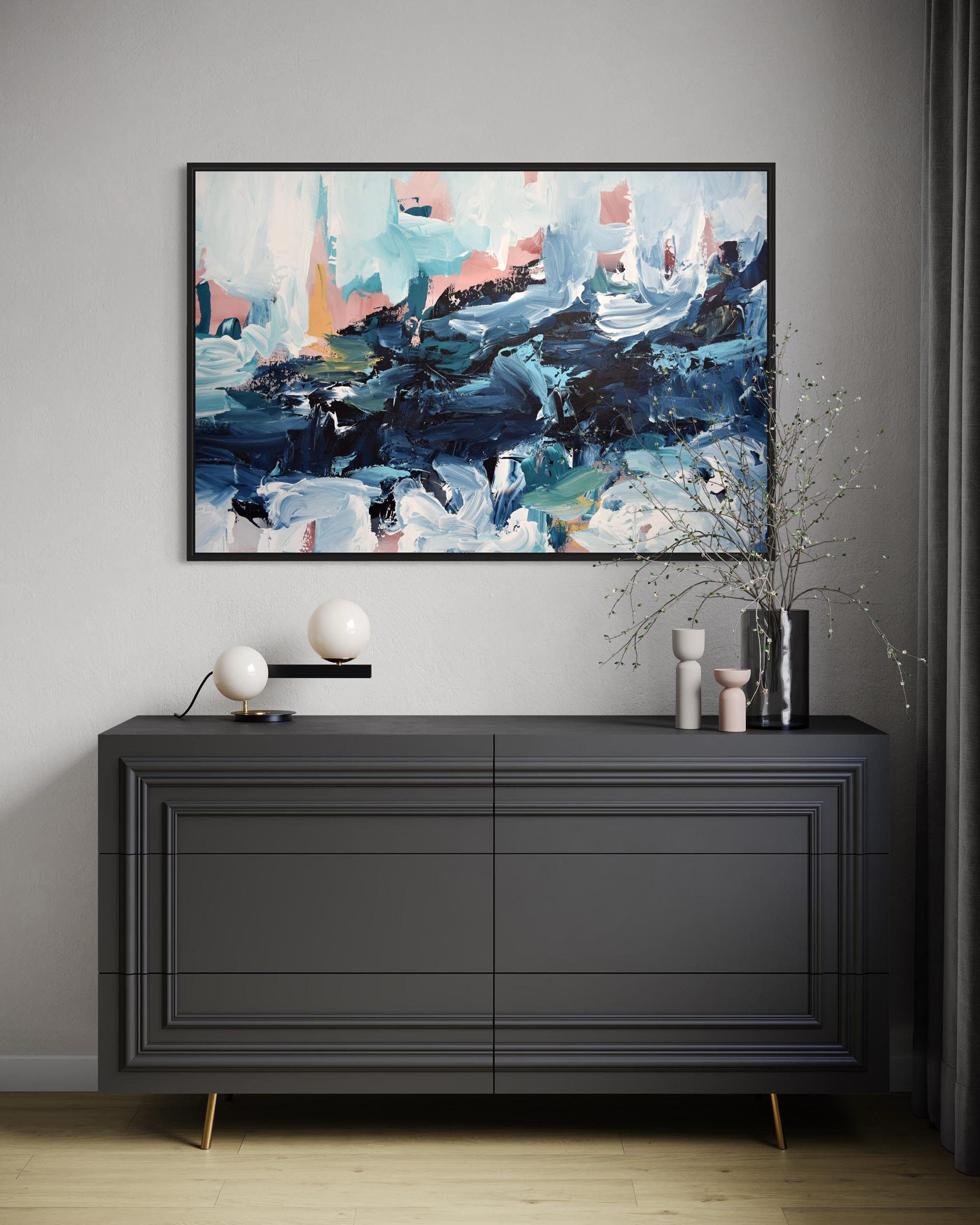 Abstract painting above a black dresser with decorative items in a room.