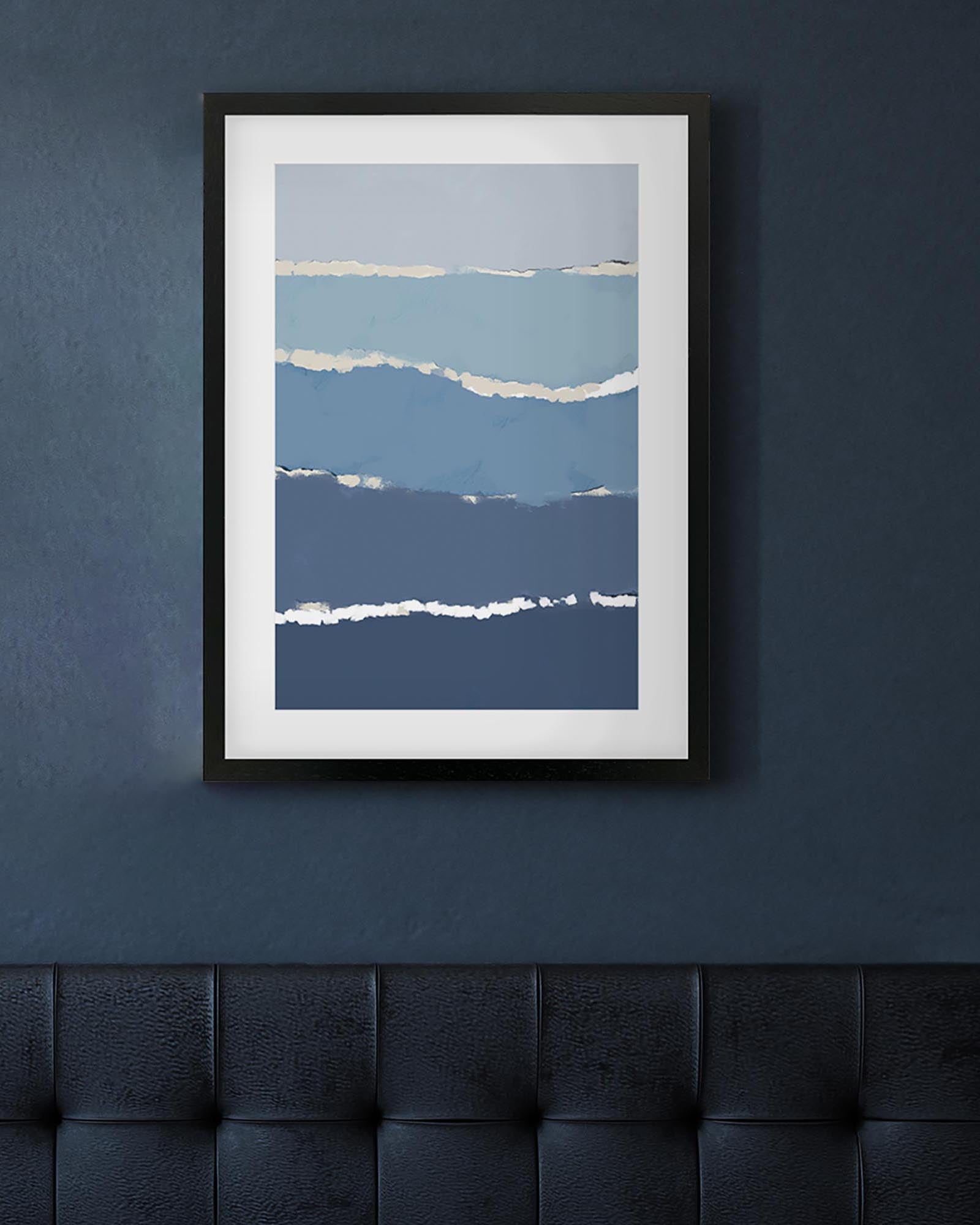 Framed abstract art print with blue and white stripes on a dark blue wall.