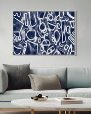 Abstract art piece on a wall above a sofa in a living room