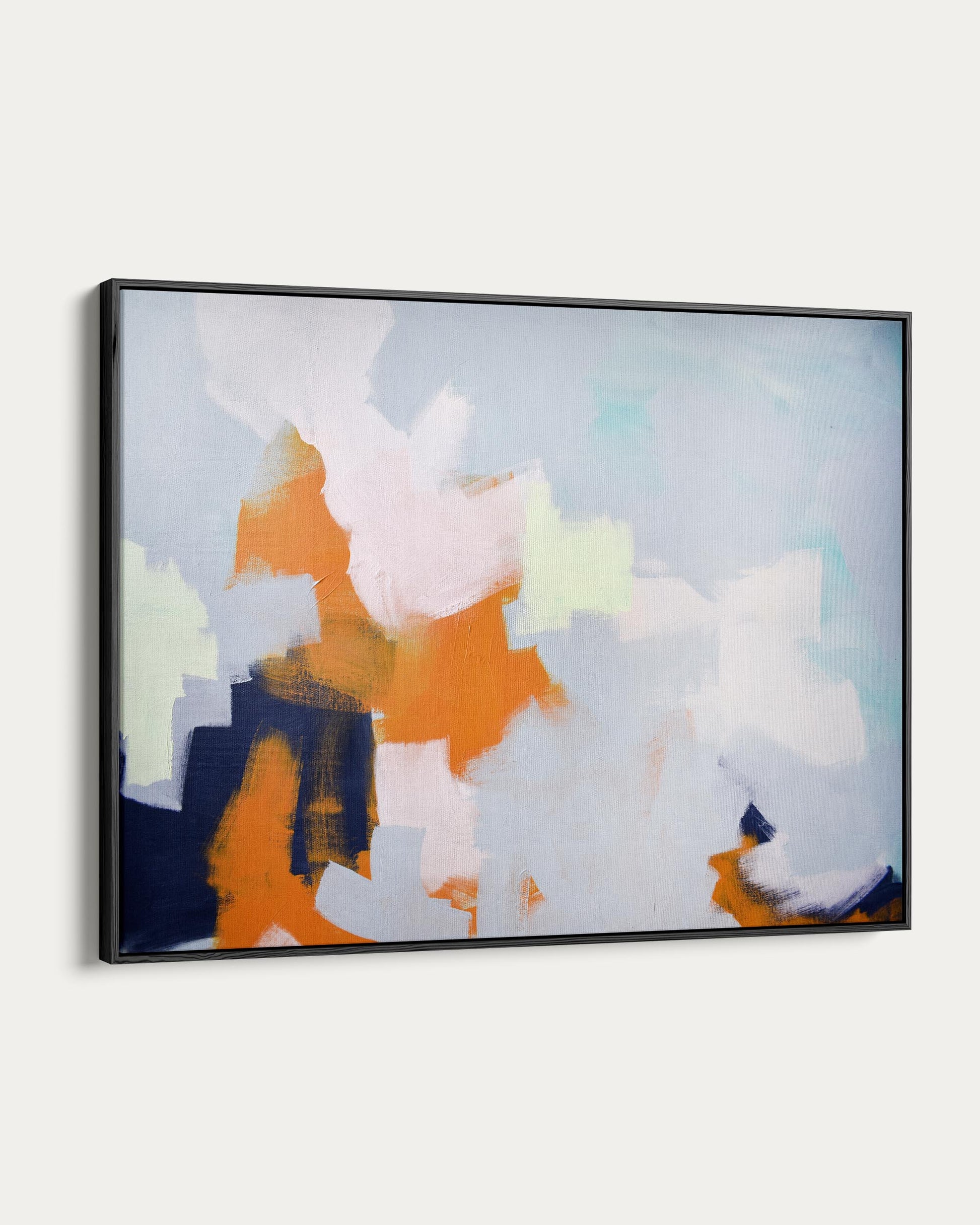 Framed abstract art with orange, blue, and white colors on a light gray background