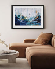 Abstract painting on a wall above a brown sofa in a living room.