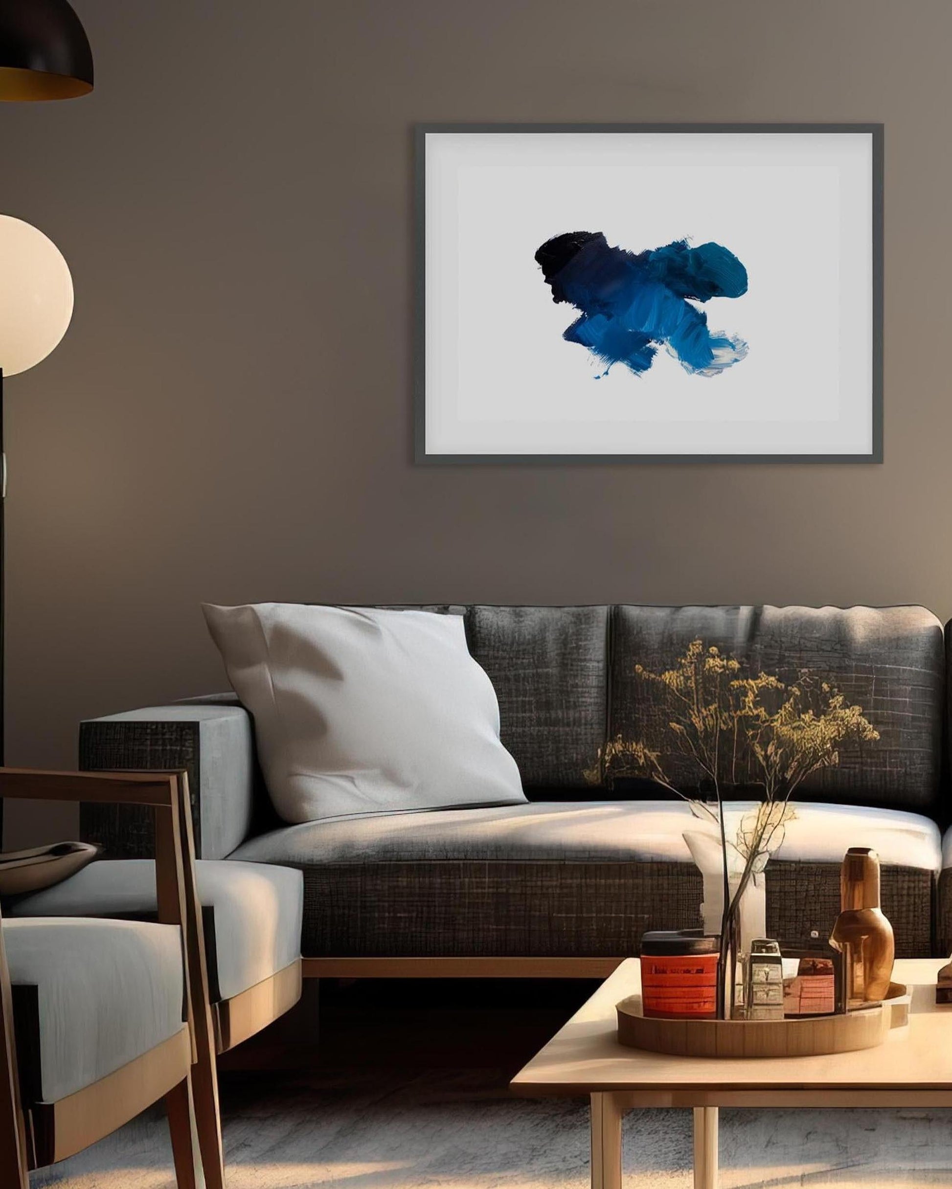 Living room with a gray sofa, coffee table, and abstract art on the wall.