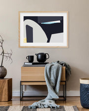 Modern interior with abstract art, wooden furniture, and decorative items.