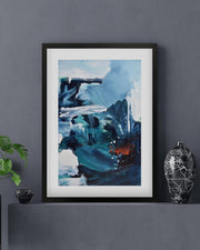 Framed abstract art piece on a dark gray wall with decorative elements.