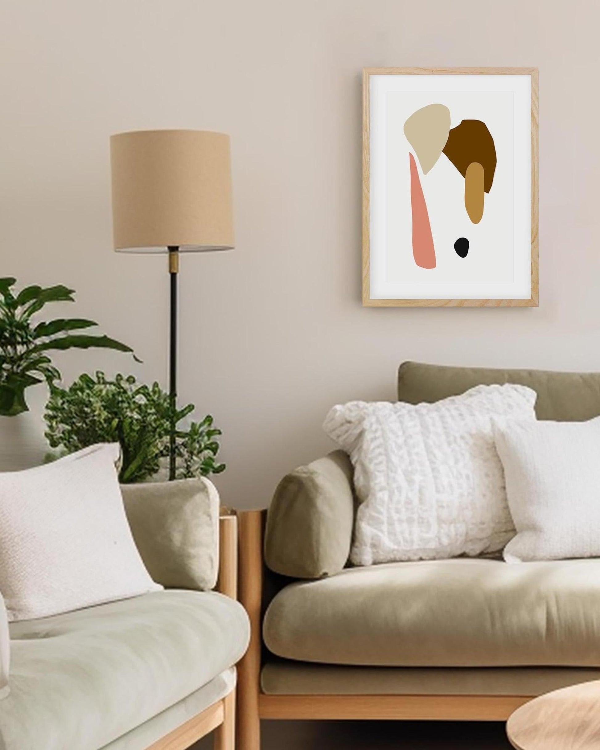 Living room with beige sofa, lamp, and abstract art on the wall