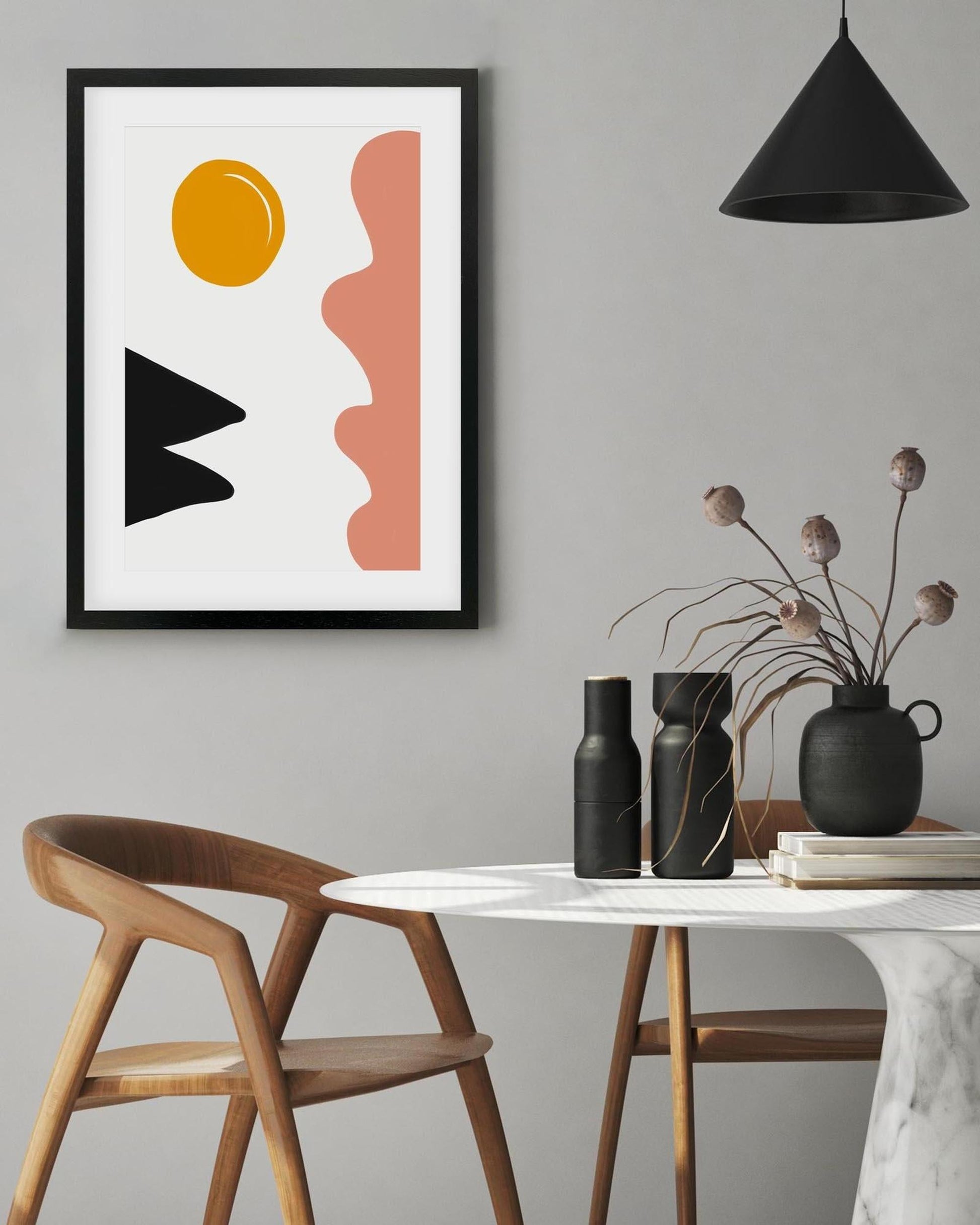 Modern interior with abstract art, black pendant light, and minimal decor.