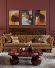 modern bold burgundy living room with re marble table ball legs with modern abstract expressive canvas art on wall