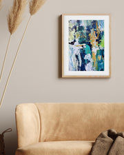 Abstract painting on a wall above a beige sofa with decorative elements.