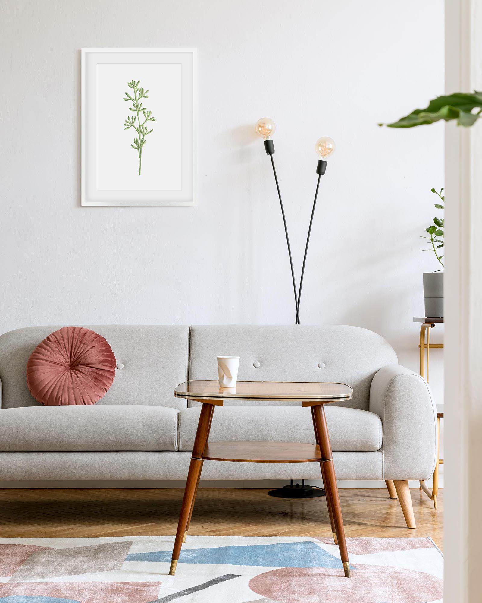 Modern living room with a gray sofa, wooden side table, and decorative elements.