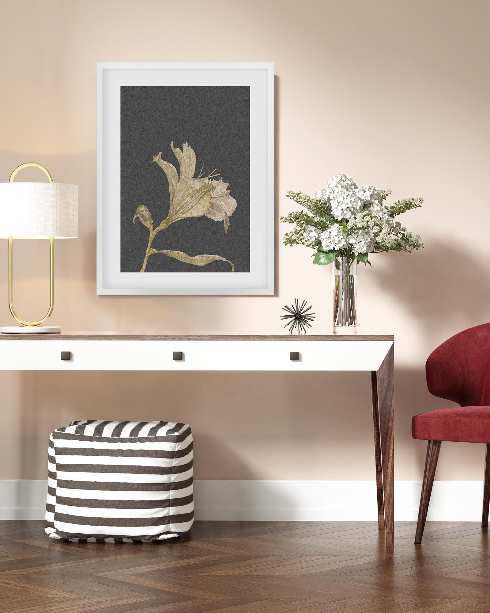 Modern interior with a desk, lamp, and decorative items on a beige wall.