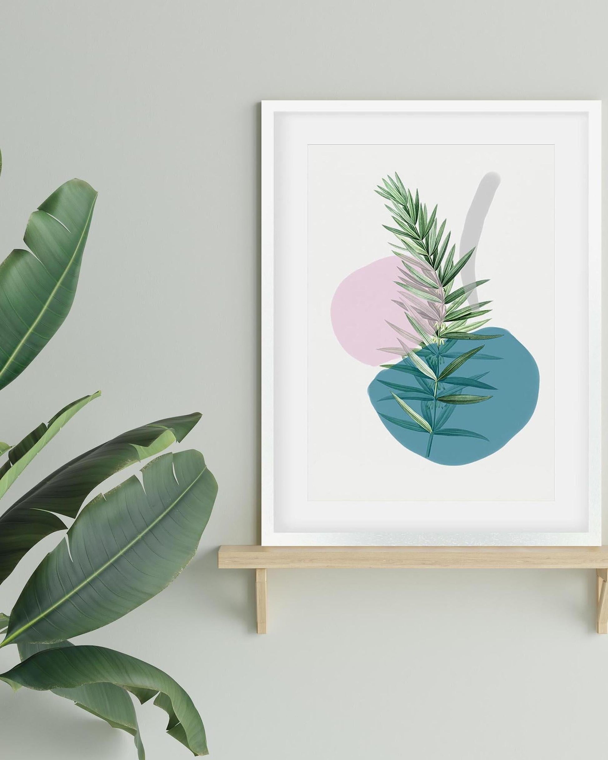 Framed artwork with abstract design of leaves on a light gray wall