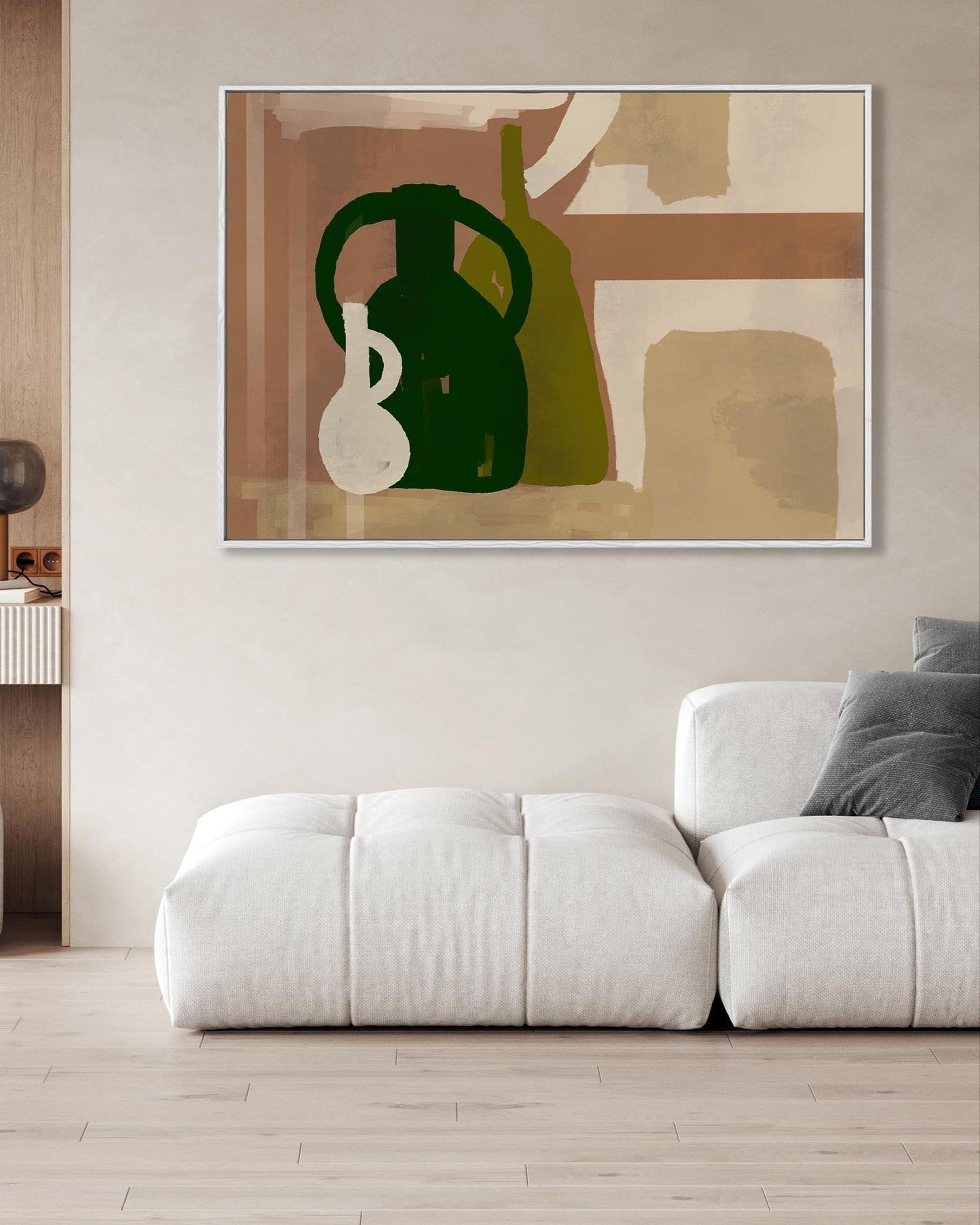 Modern living room with a white sofa, abstract art on the wall, and a side table.