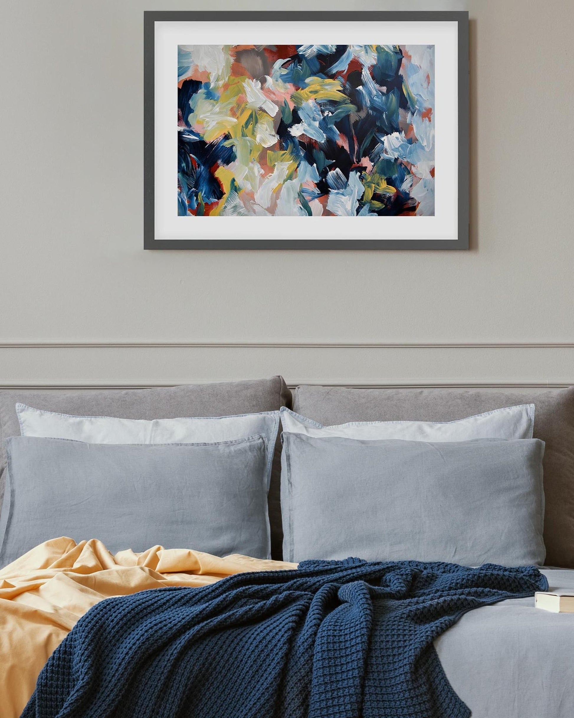 Bedroom with abstract art on the wall above a bed