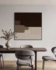 Dining room with a wooden table and gray chairs, abstract art on the wall.