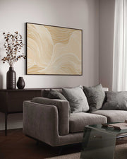 Modern living room with a gray sofa, coffee table, and abstract wall art.