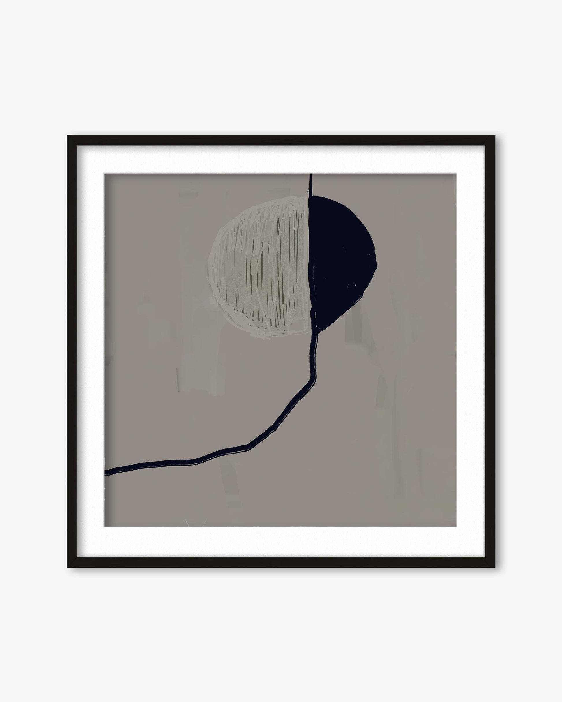 Framed abstract art with black and white shapes on a beige background