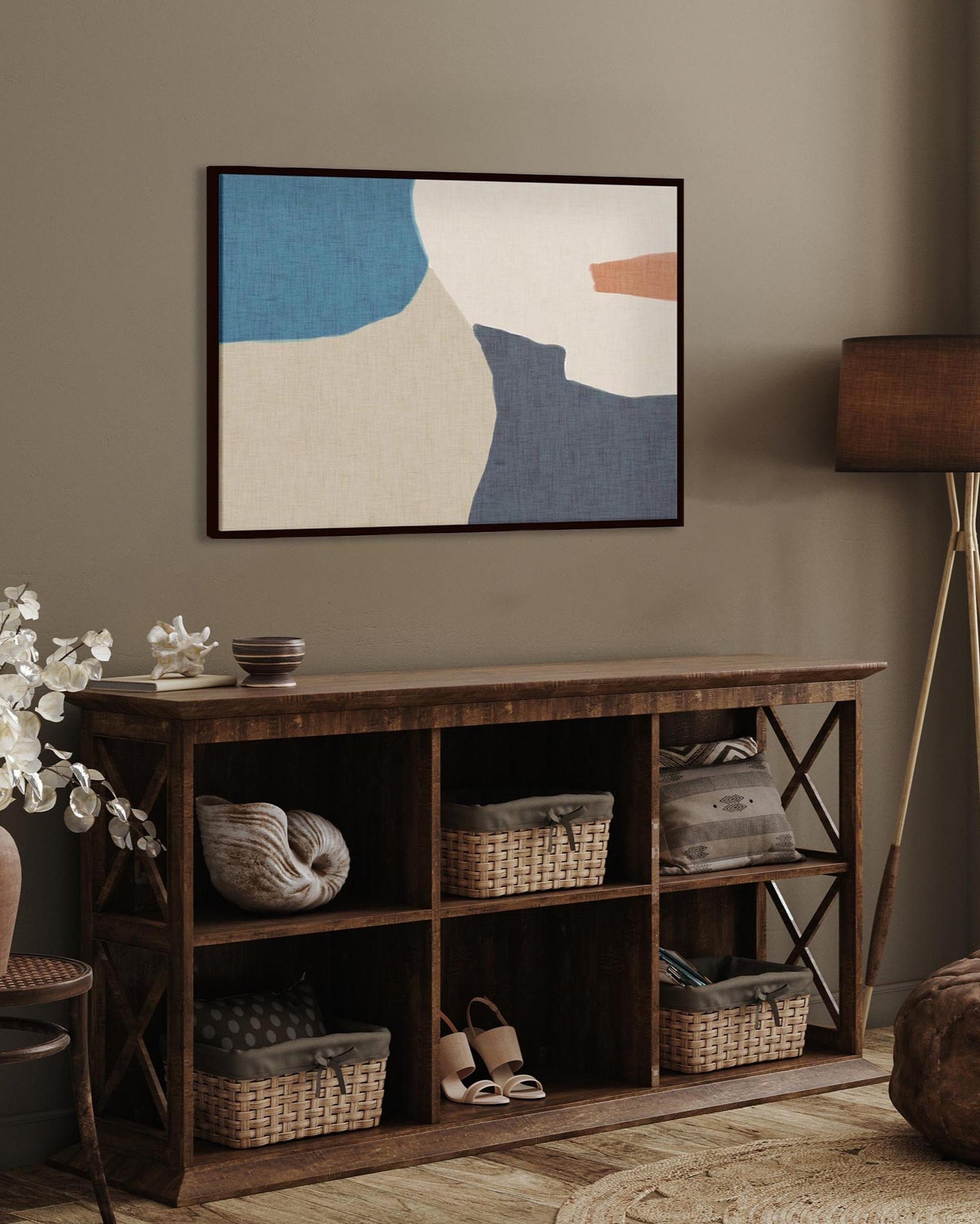 Wooden shelf with decorative items against a wall with abstract art