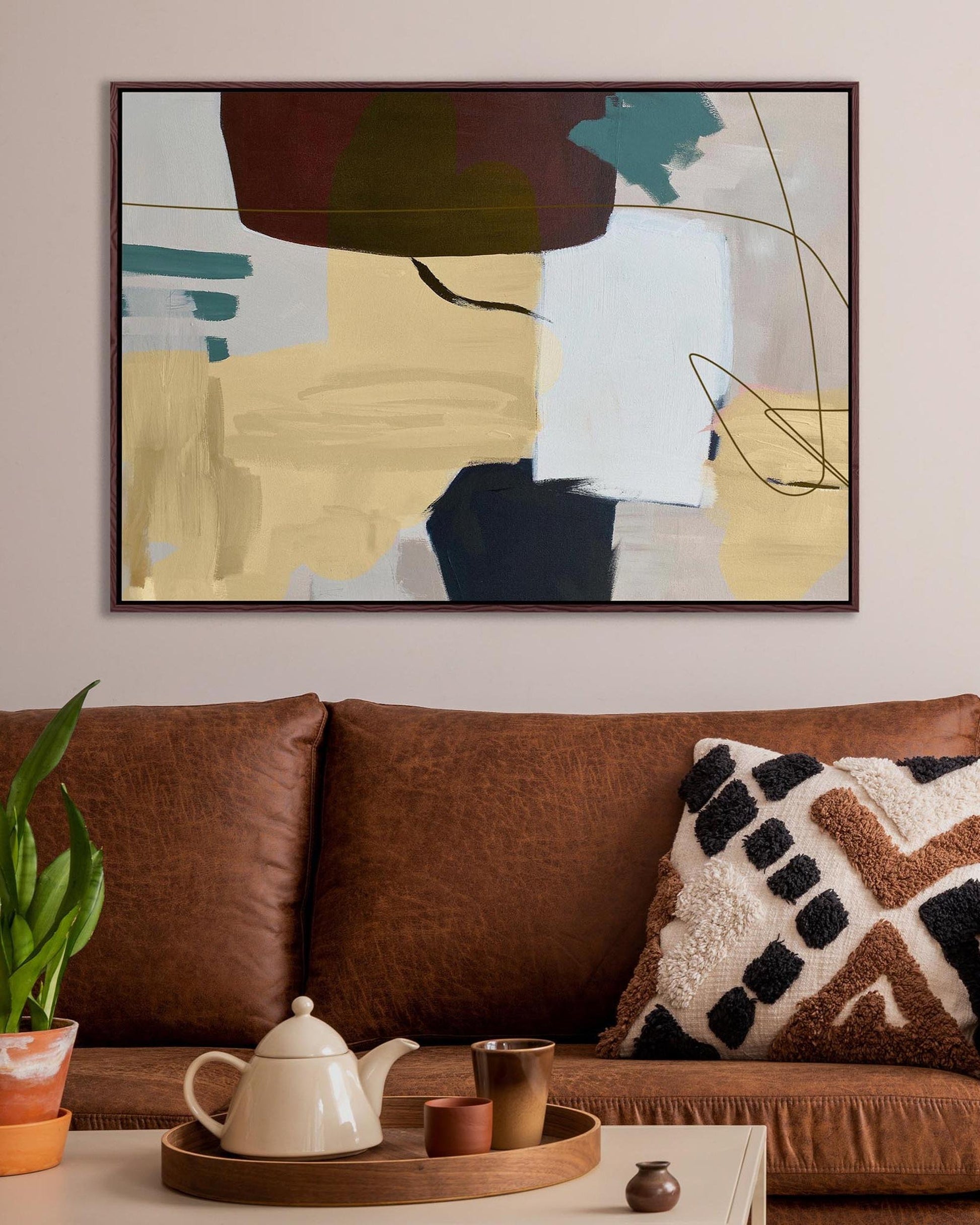 Living room with a brown sofa, abstract painting, and decorative items.
