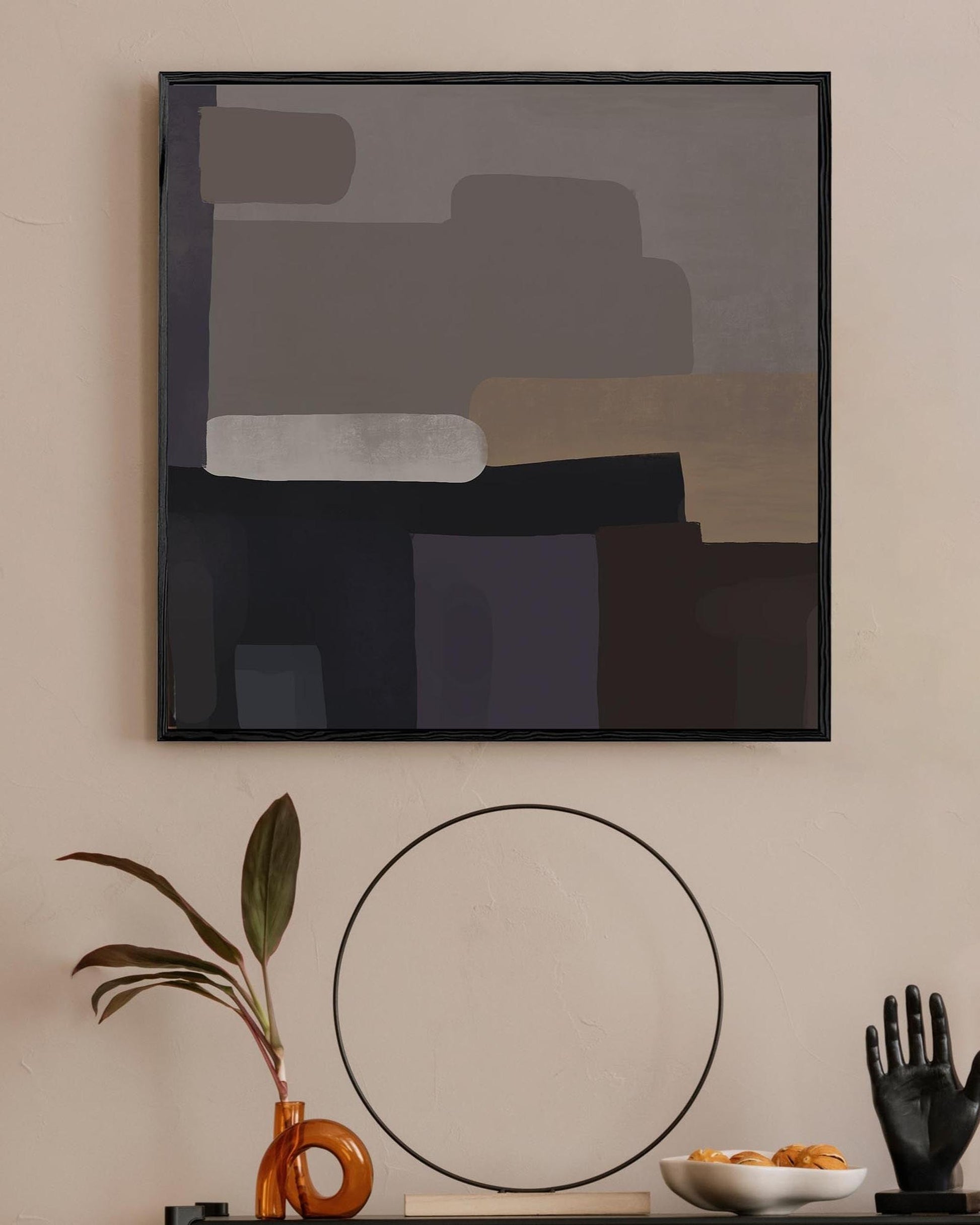 Abstract art piece on a wall with decorative items below