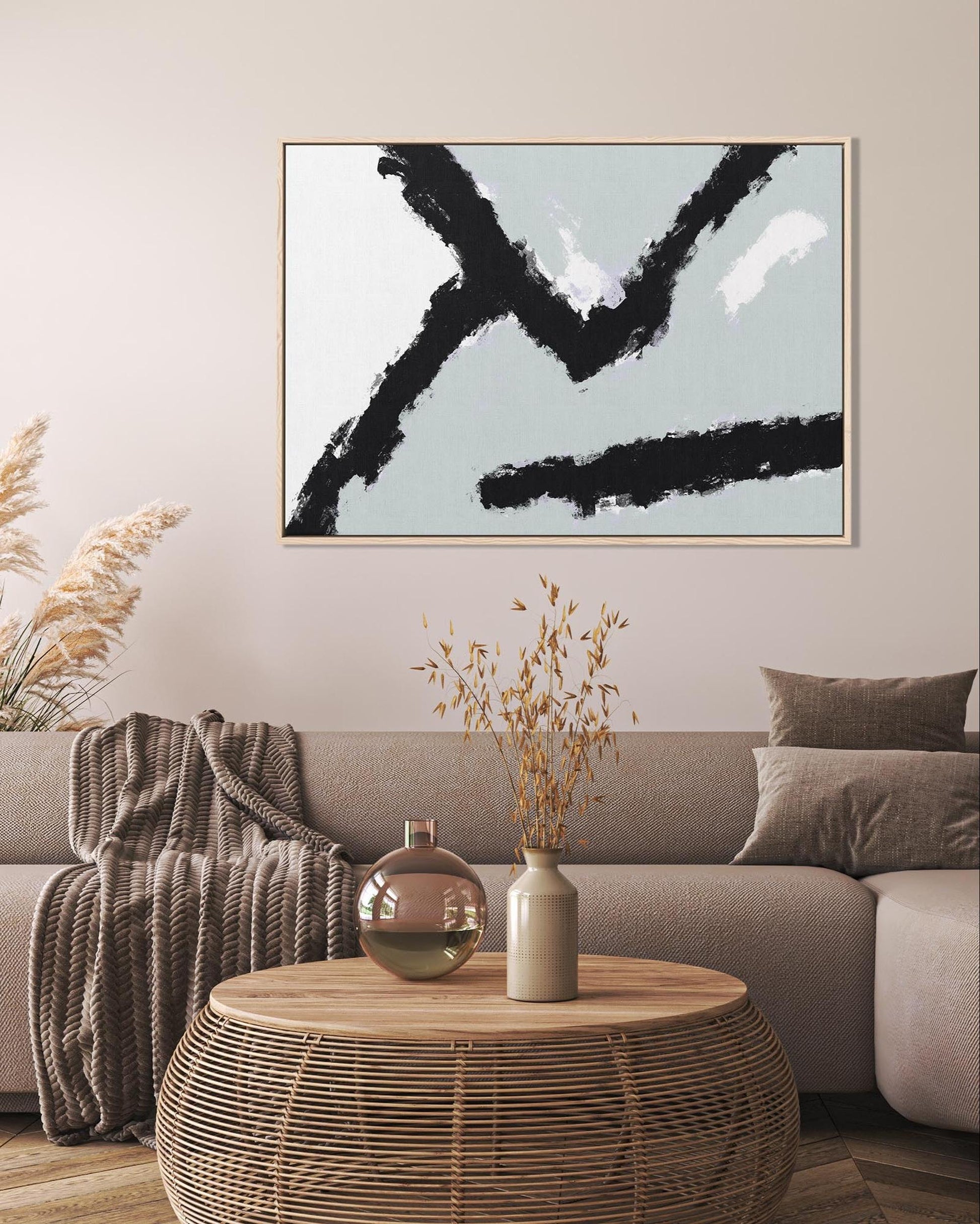 Modern living room with a sofa, coffee table, and abstract art on the wall.