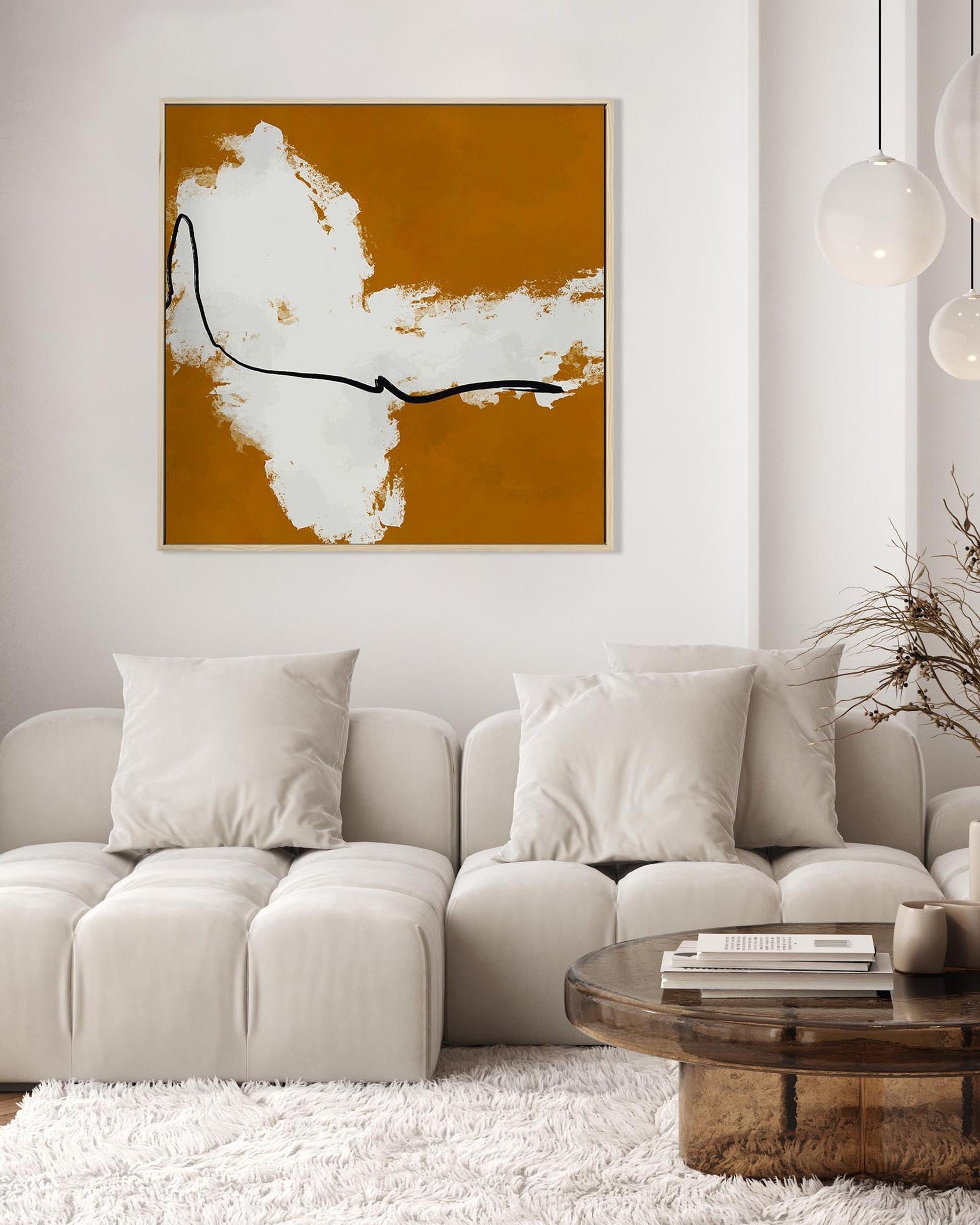 Modern living room with a beige sectional sofa, abstract art on the wall, and a wooden coffee table.