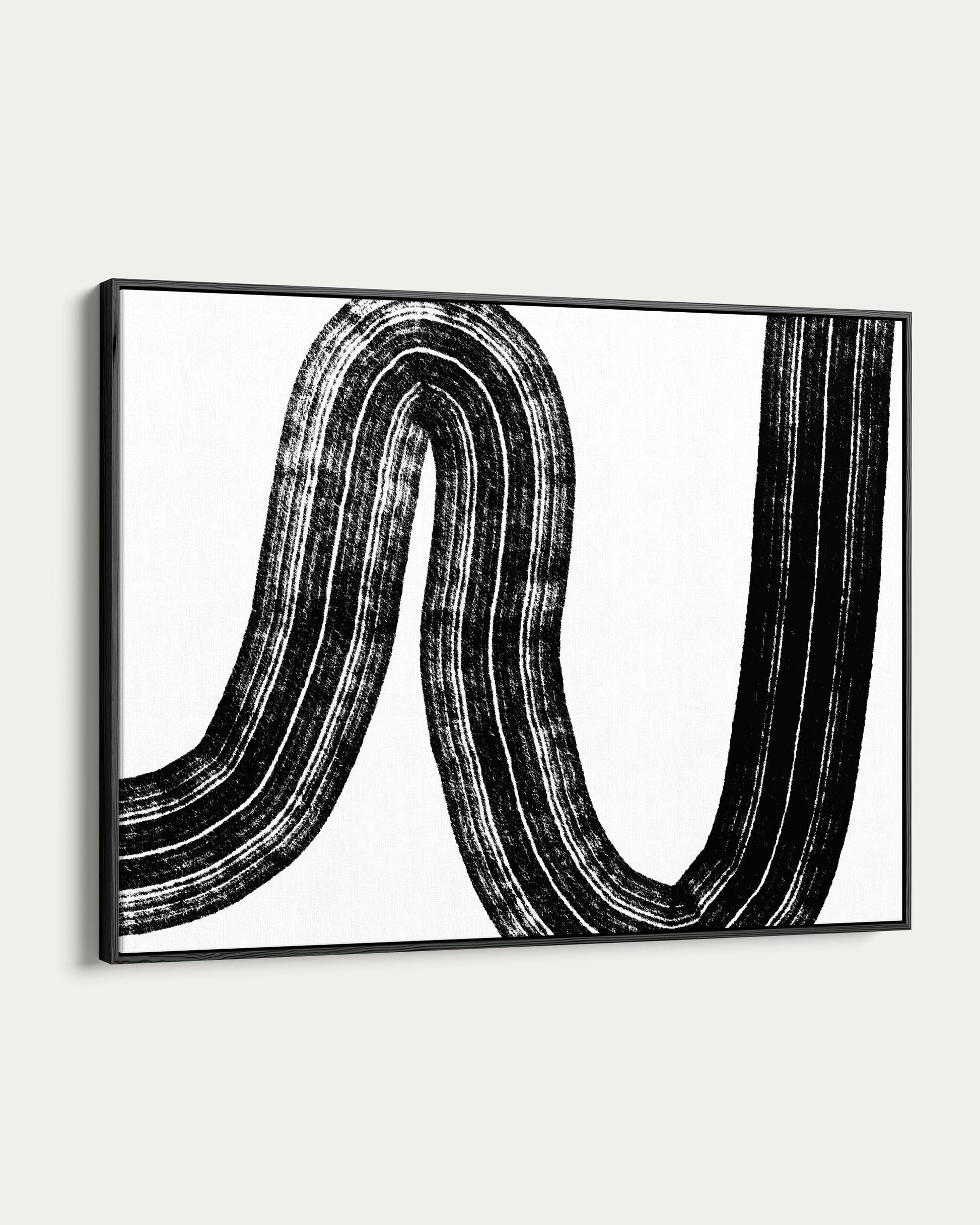 Black and white abstract art print on a white wall