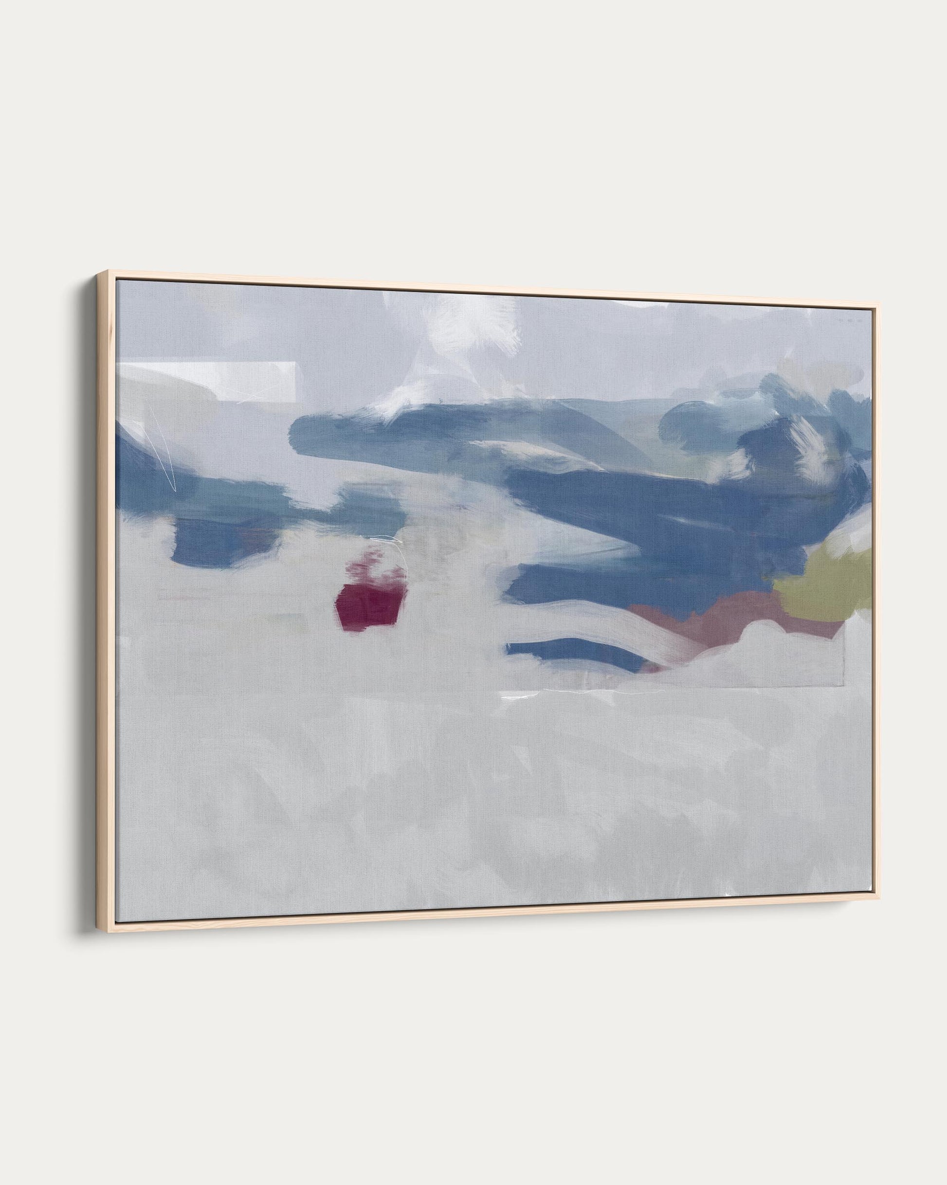 Framed abstract art with blue, white, and red colors on a white wall