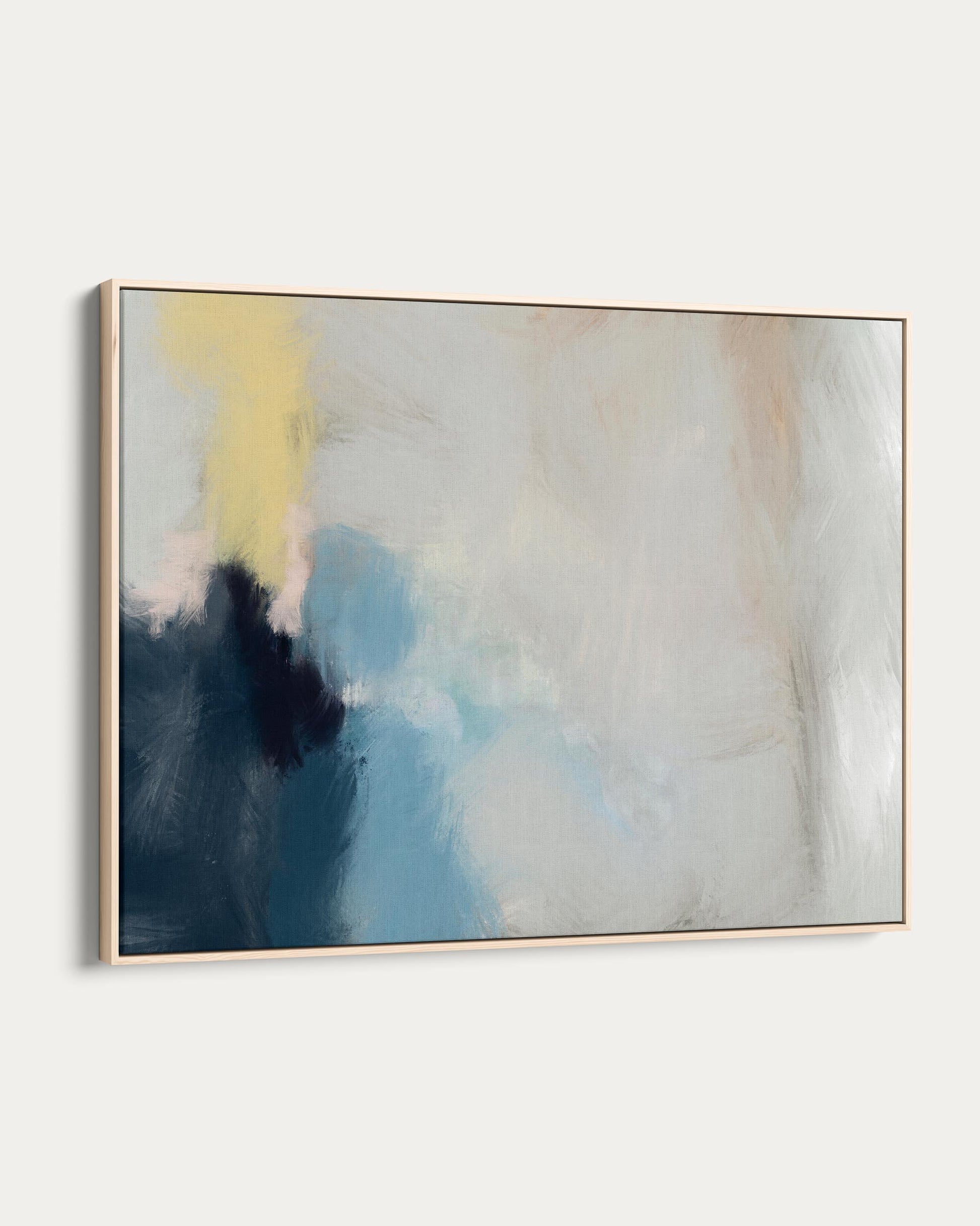 Abstract painting with blue, yellow, and beige colors on a white wall