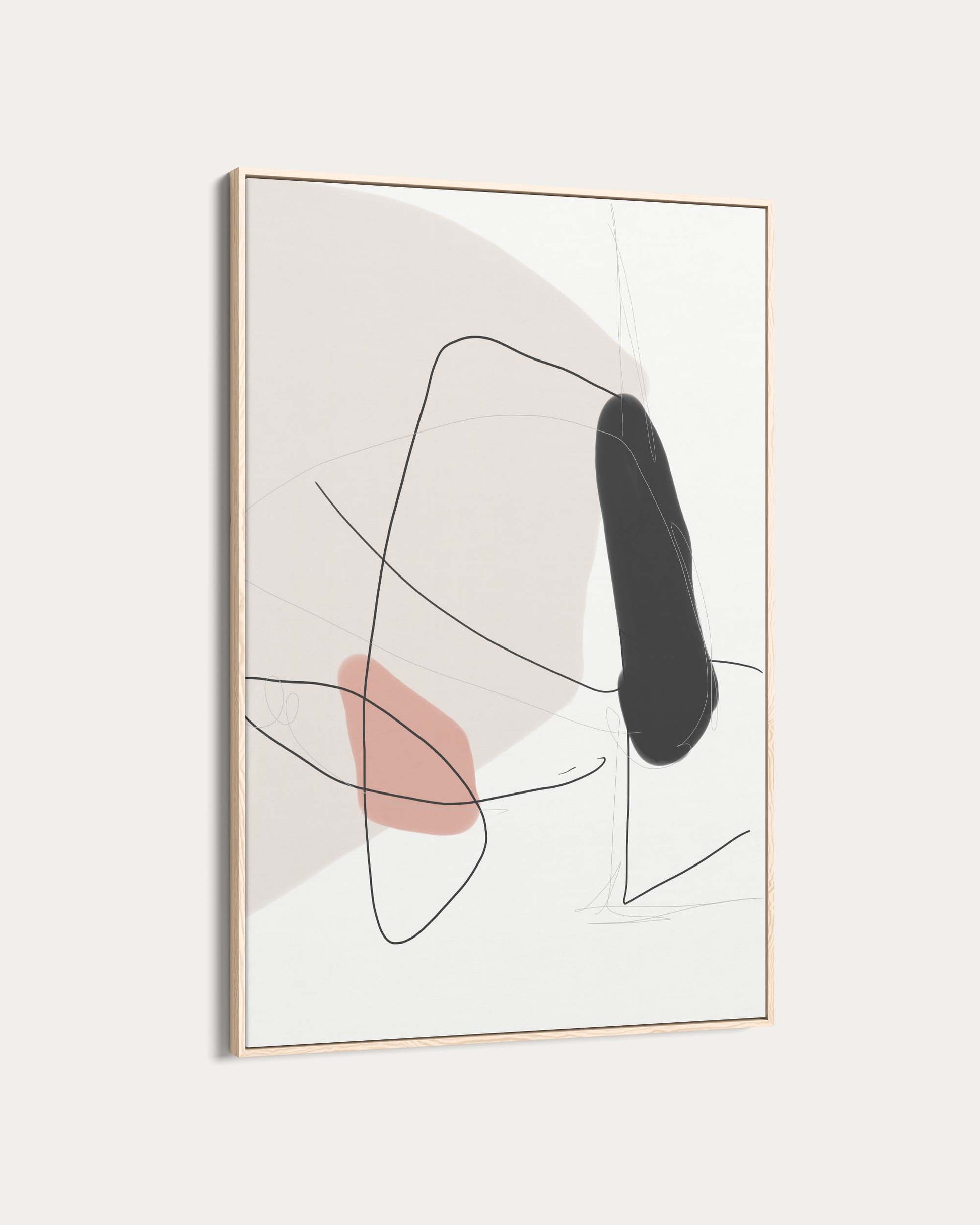 Abstract art print with black and pink shapes in a gold frame on a white background