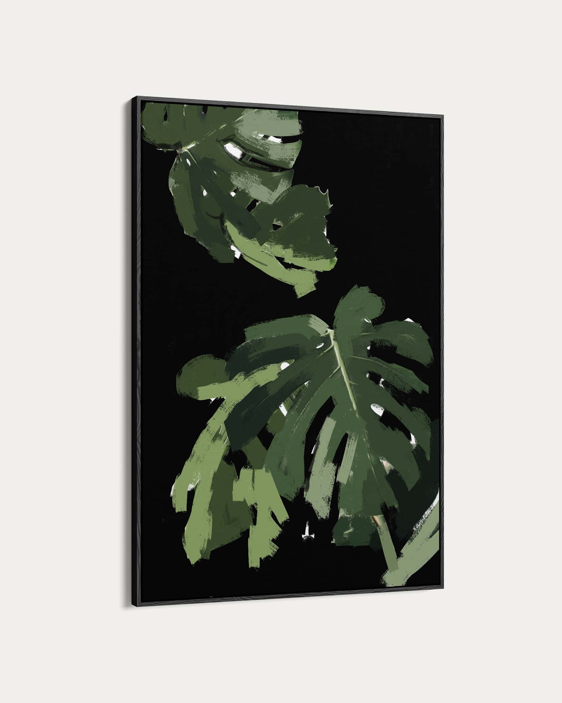 Framed artwork with green leaves on a black background