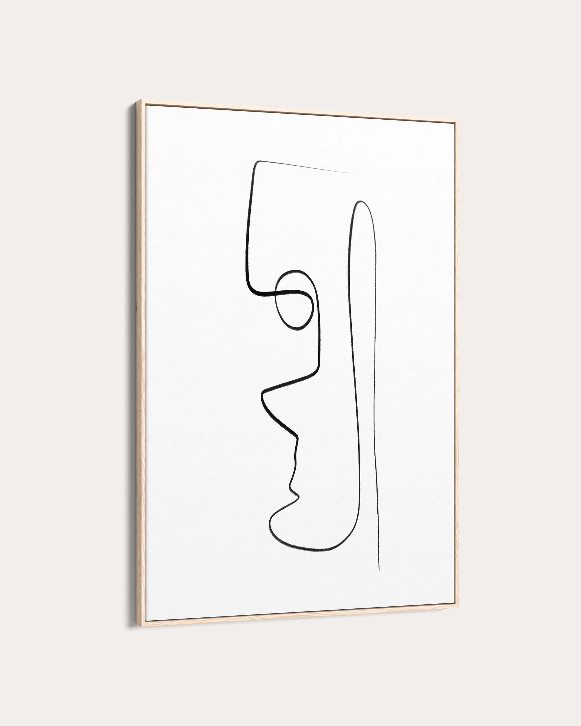 Framed abstract line art of a face on a white wall