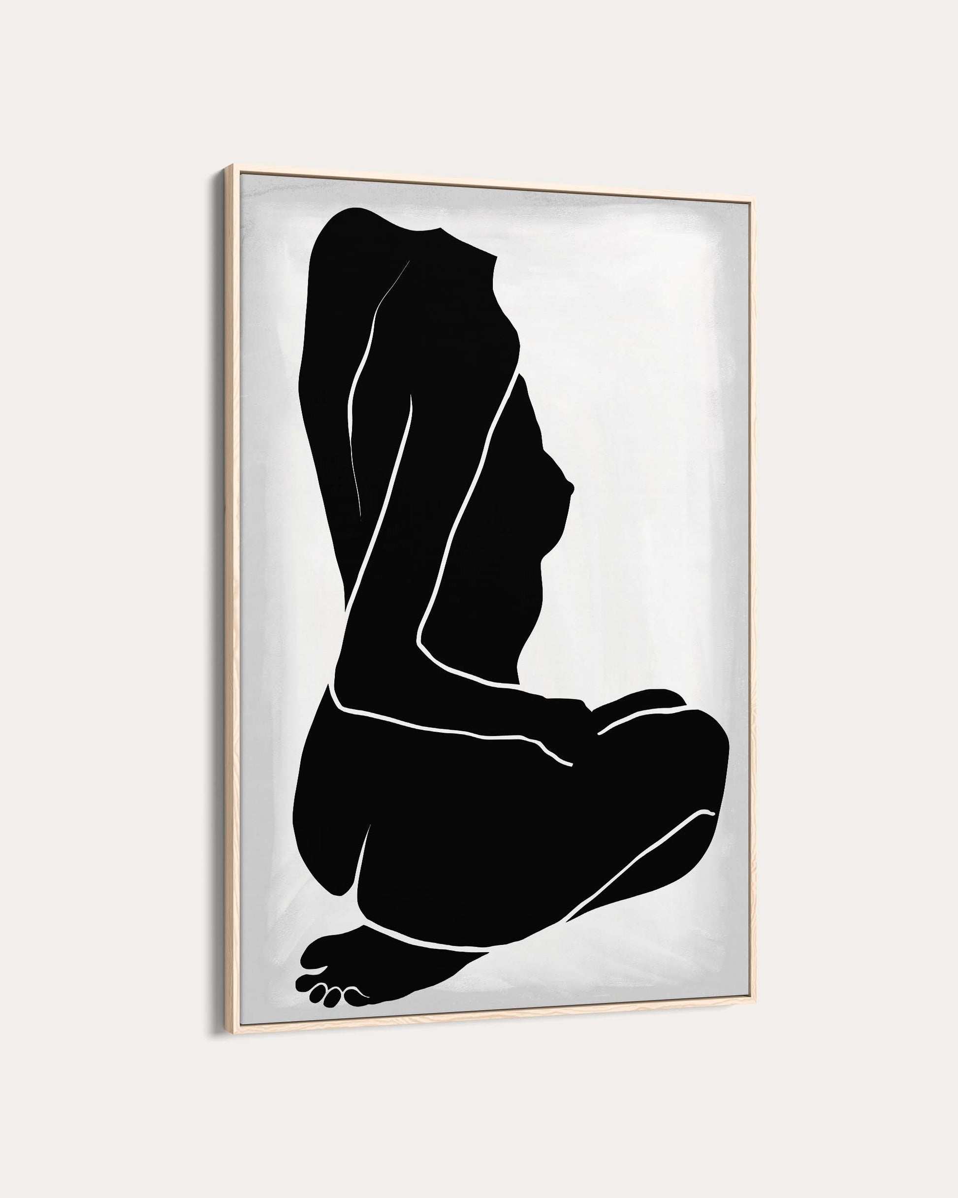 Framed artwork of a black silhouette of a person sitting on a white background