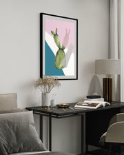 Modern interior with a framed artwork of a cactus on a wall above a desk.