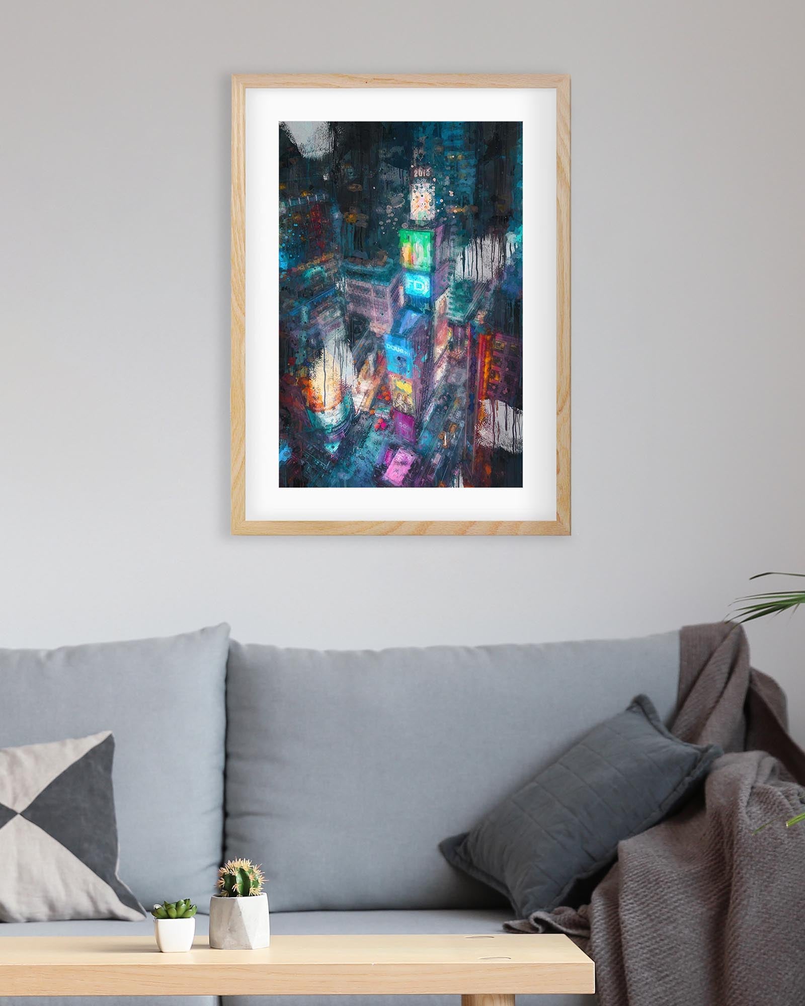 Framed abstract artwork above a gray sofa in a living room.